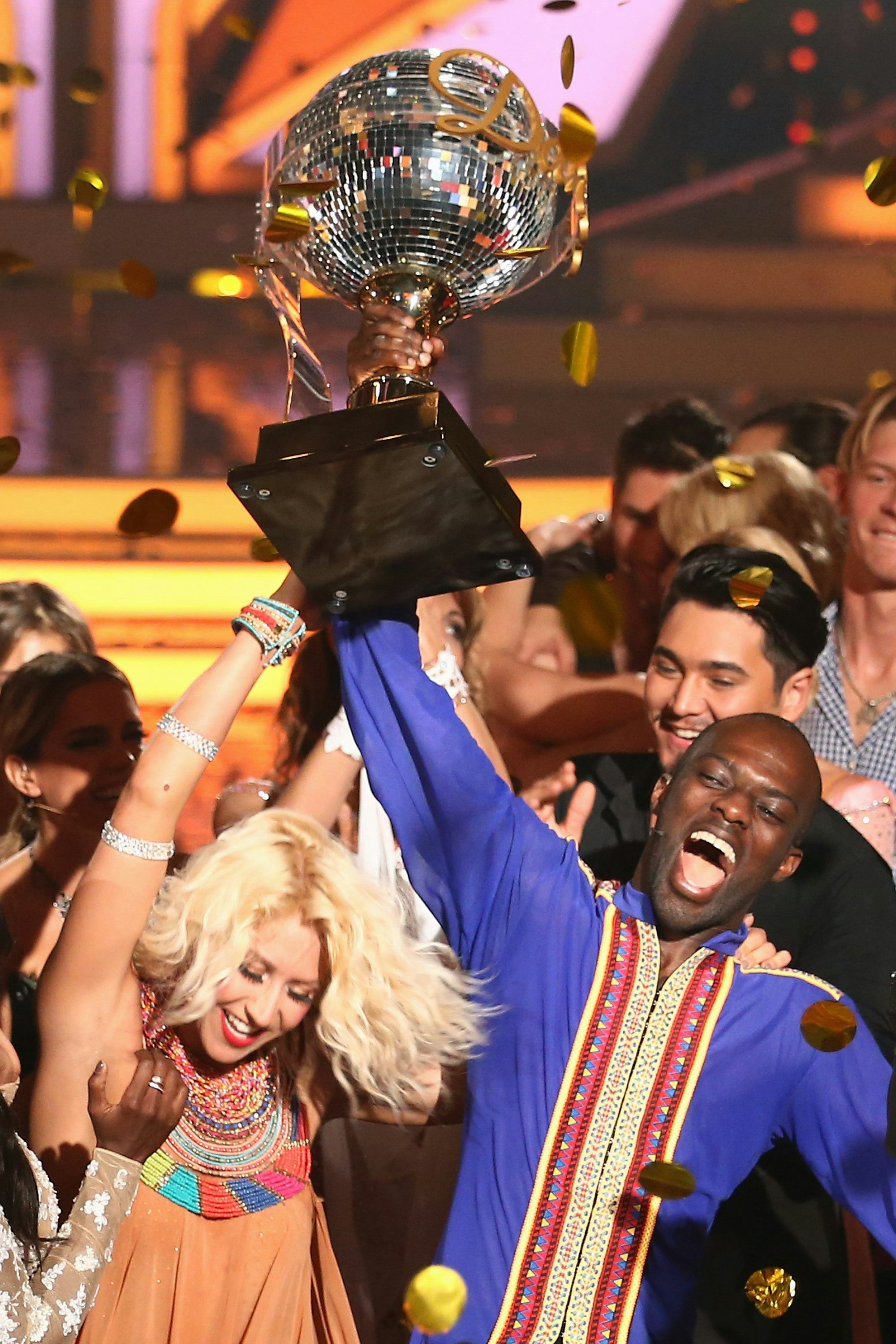 COLOGNE, GERMANY - JUNE 05: Hans Sarpei and Kathrin Menzinger celebrate after winning the award during the final show of the television competition 'Let's Dance' on June 5, 2015 in Cologne, Germany. (Photo by Andreas Rentz/Getty Images)