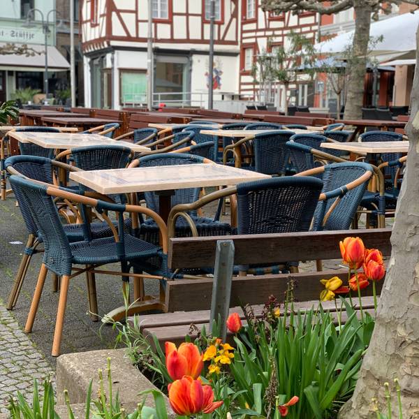Leere Tische und Stühle vor einem Restaurant in Euskirchen.