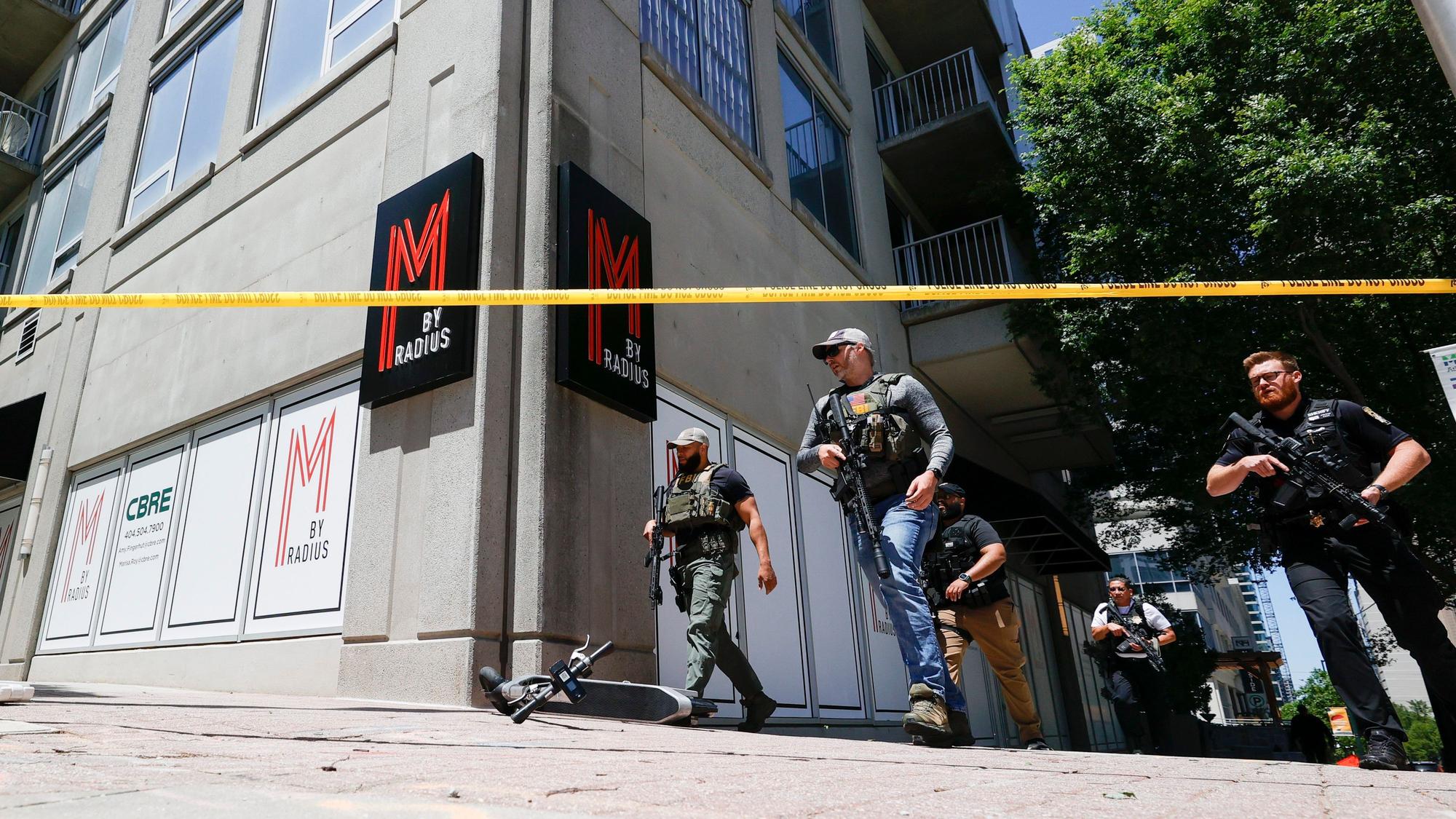 Law enforcement officers arrive near the scene of an active shooter on Wednesday, May 3, 2023 in Atlanta. Atlanta police said there had been no additional shots fired since the initial shooting unfolded inside a building in a commercial area with many office towers and high-rise apartments. (AP Photo/Alex Slitz)