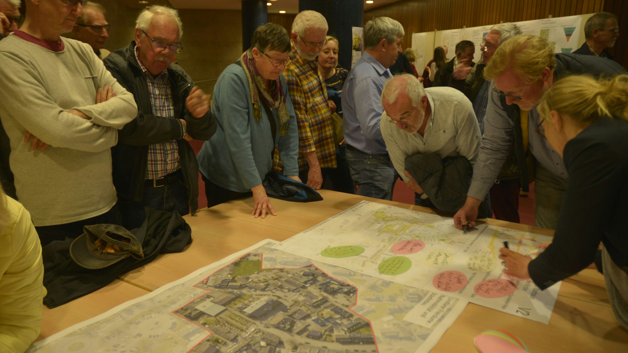 Bürger beraten bei der Bürgerbeteiligung zum Stadtentwicklungsprogramm Isek in einem Workshop über Pläne.