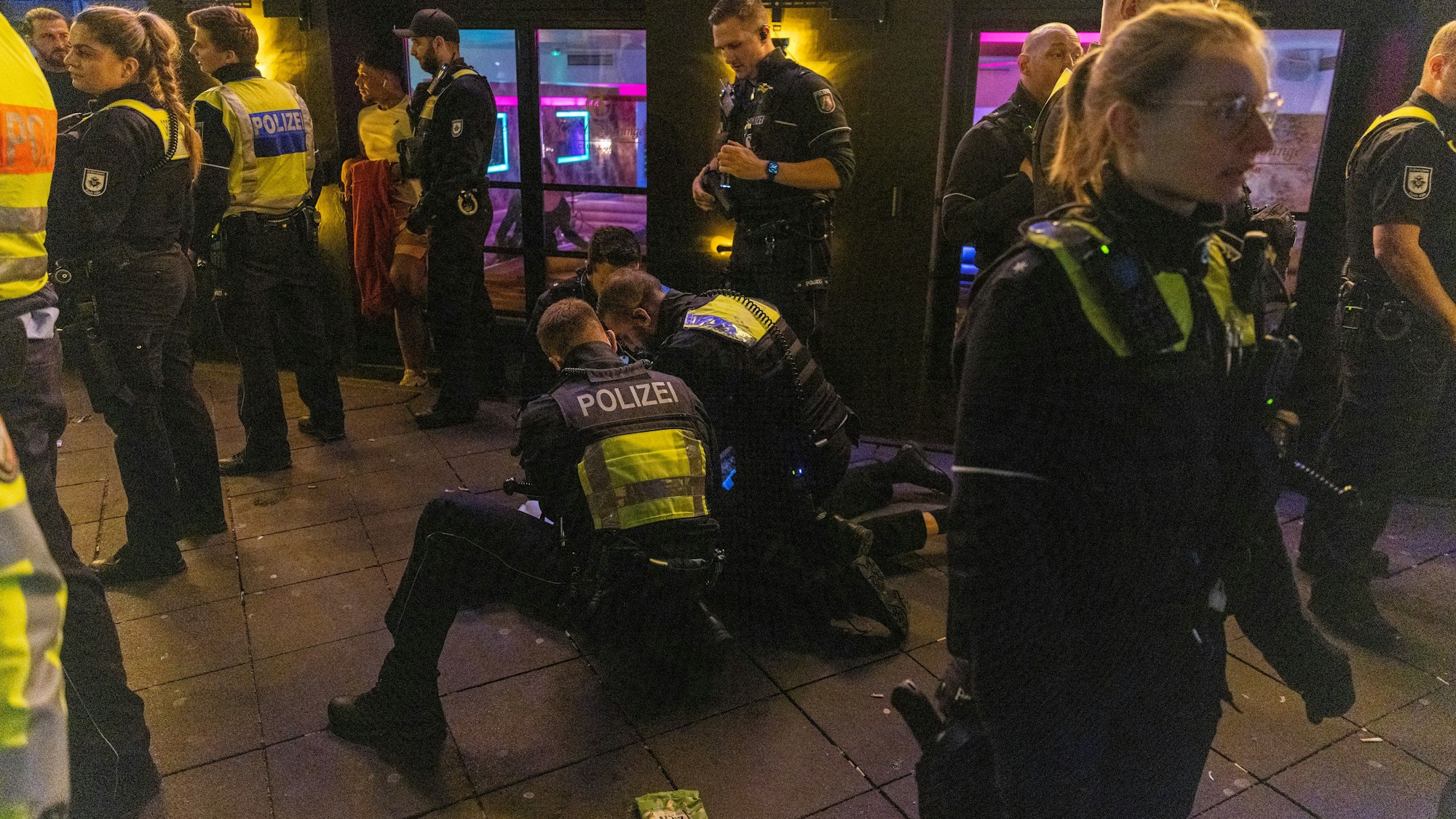 Polizisten nehmen einen Mann fest.