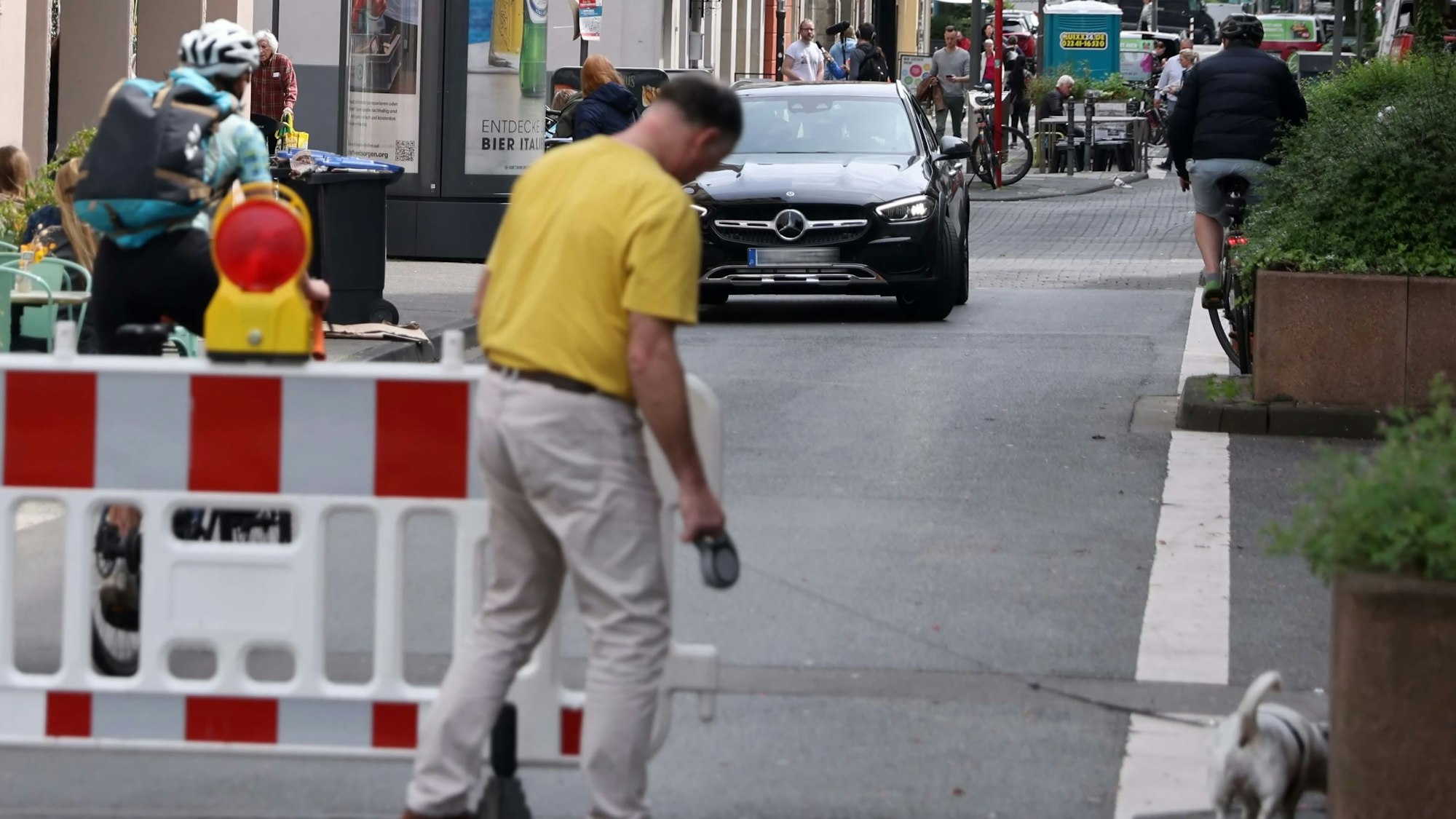 In der autofreie Zone an der Deutzer Freiheit in Köln sieht man Fußgänger und Fahrradfahrer.