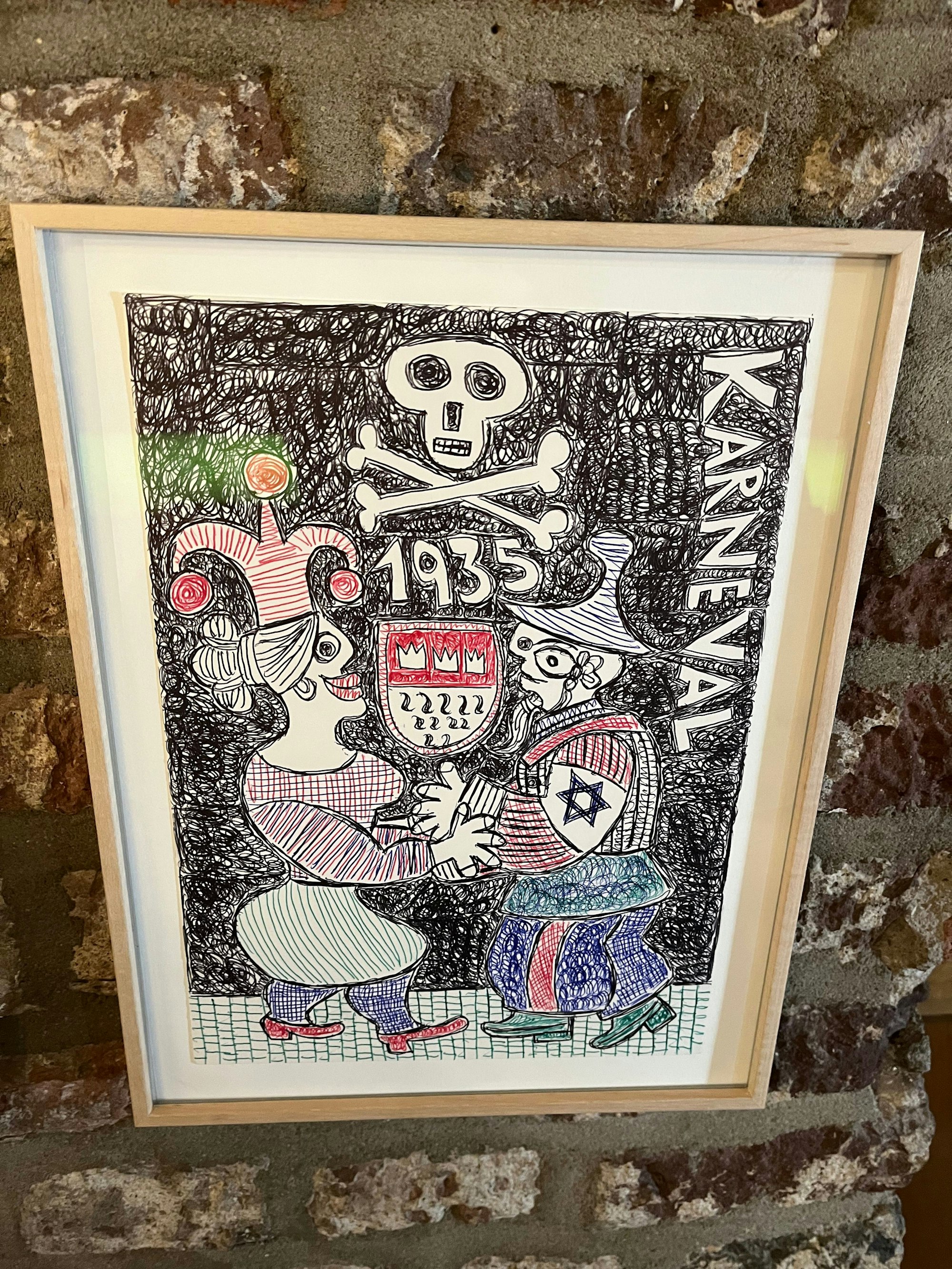 Ein Bild hängt an der Wand, darauf zu sehen sind zwei Karnevalisten, die sich die Hand halten.