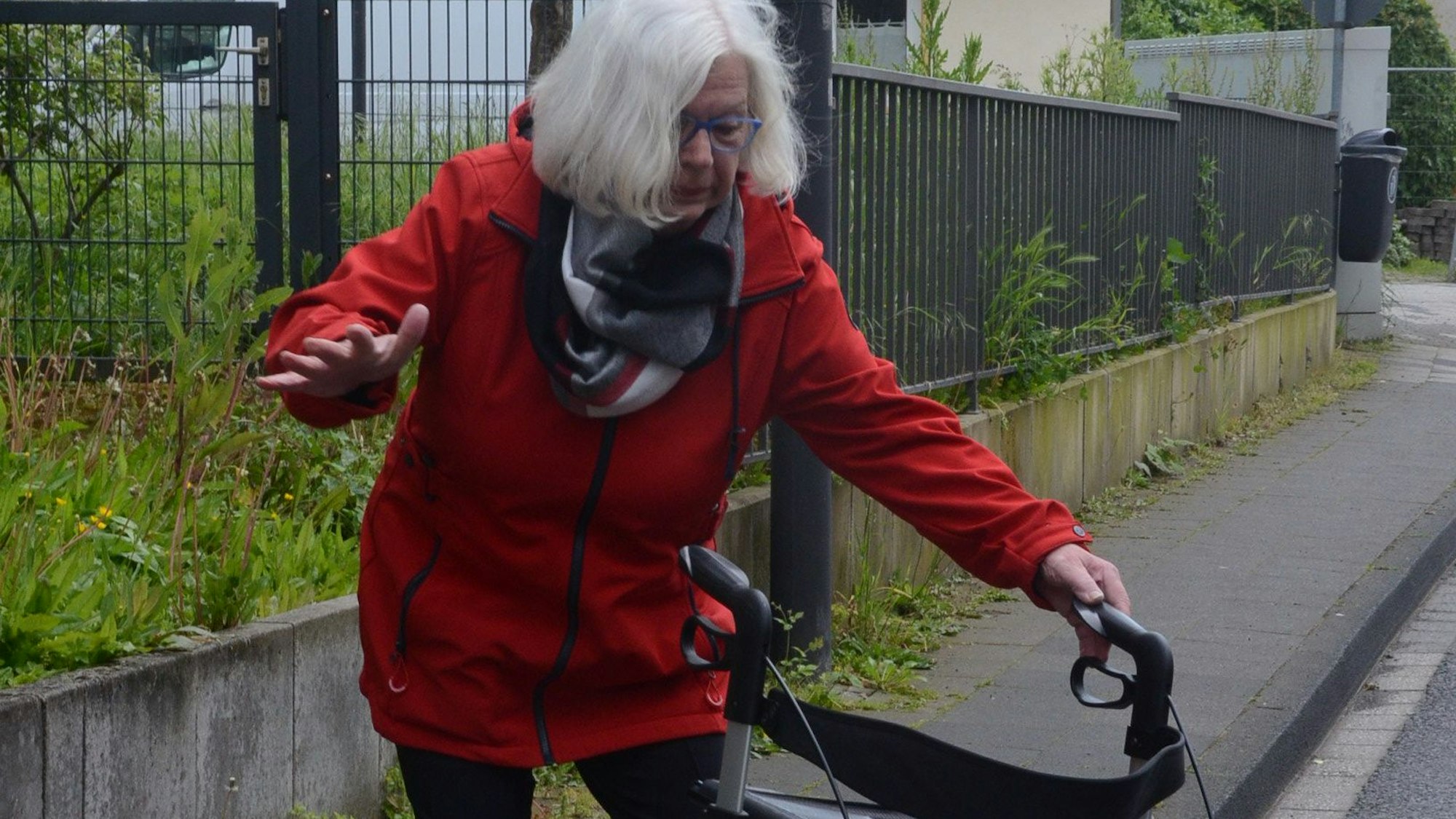 Es ist eine Seniorin zu sehen, die leicht aus dem Gleichgewicht gerät.