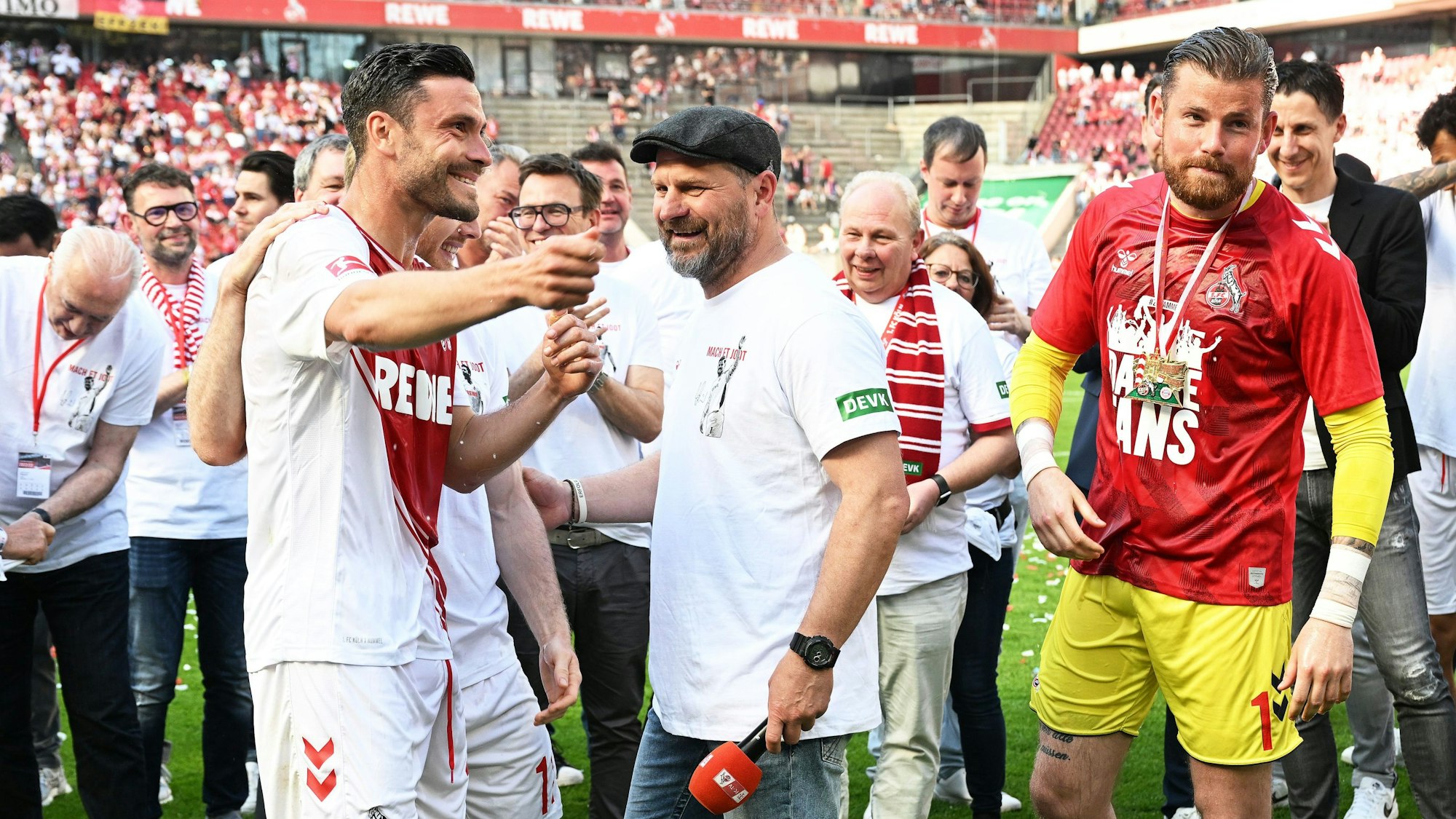 Kölns Jonas Hector (l.) und Torhüter Timo Horn (r.) reagieren bei ihrer Verabschiedung neben Trainer Steffen Baumgart.
