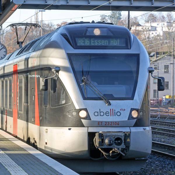 Ein Zug von Abellio steht im Hauptbahnhof. Die Sonne scheint auf die silberfarbenen Wagen.