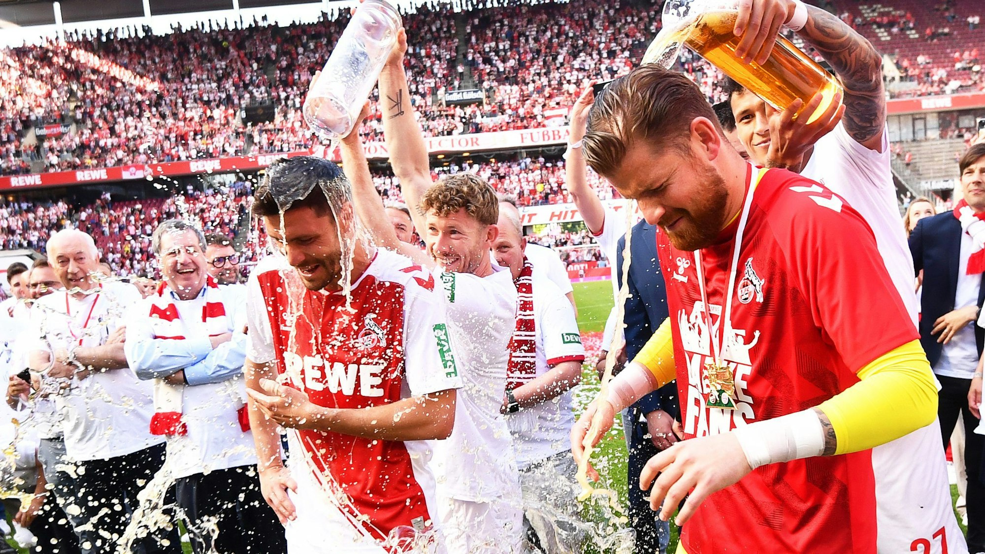 Kölns Jonas Hector (l) und Torhüter Timo Horn (r) werden bei ihrer Verabschiedung mit Bier übergossen.