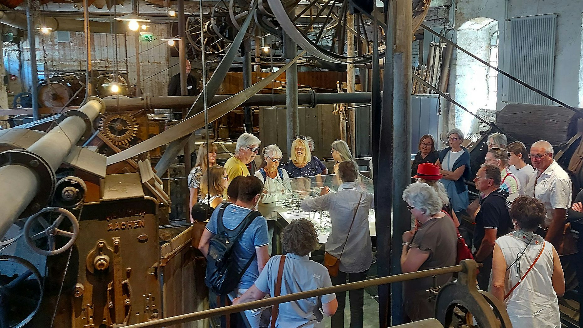 Eine Menschengruppe steht im Rahmen einer Führung in der historischen Tuchfabrik in Kuchenheim.