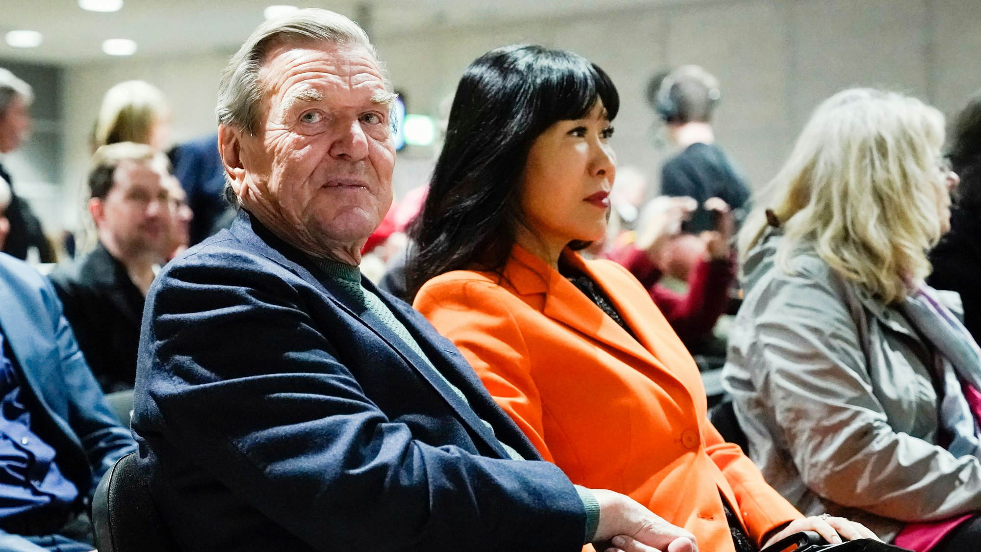 Der ehemalige Bundeskanzler Gerhard Schröder und seine Frau So-yeon Schröder-Kim sitzen bei einer Veranstaltung.