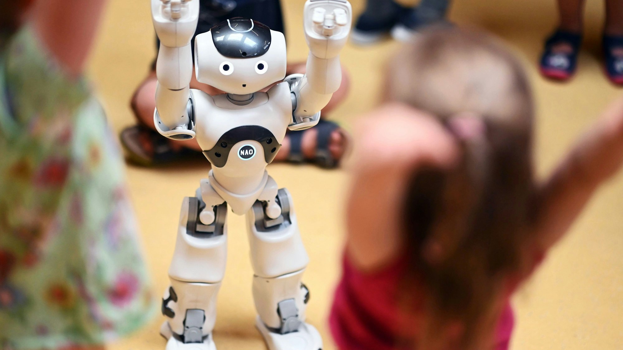 Ein Roboter macht den Kindern Bewegungsübungen vor.