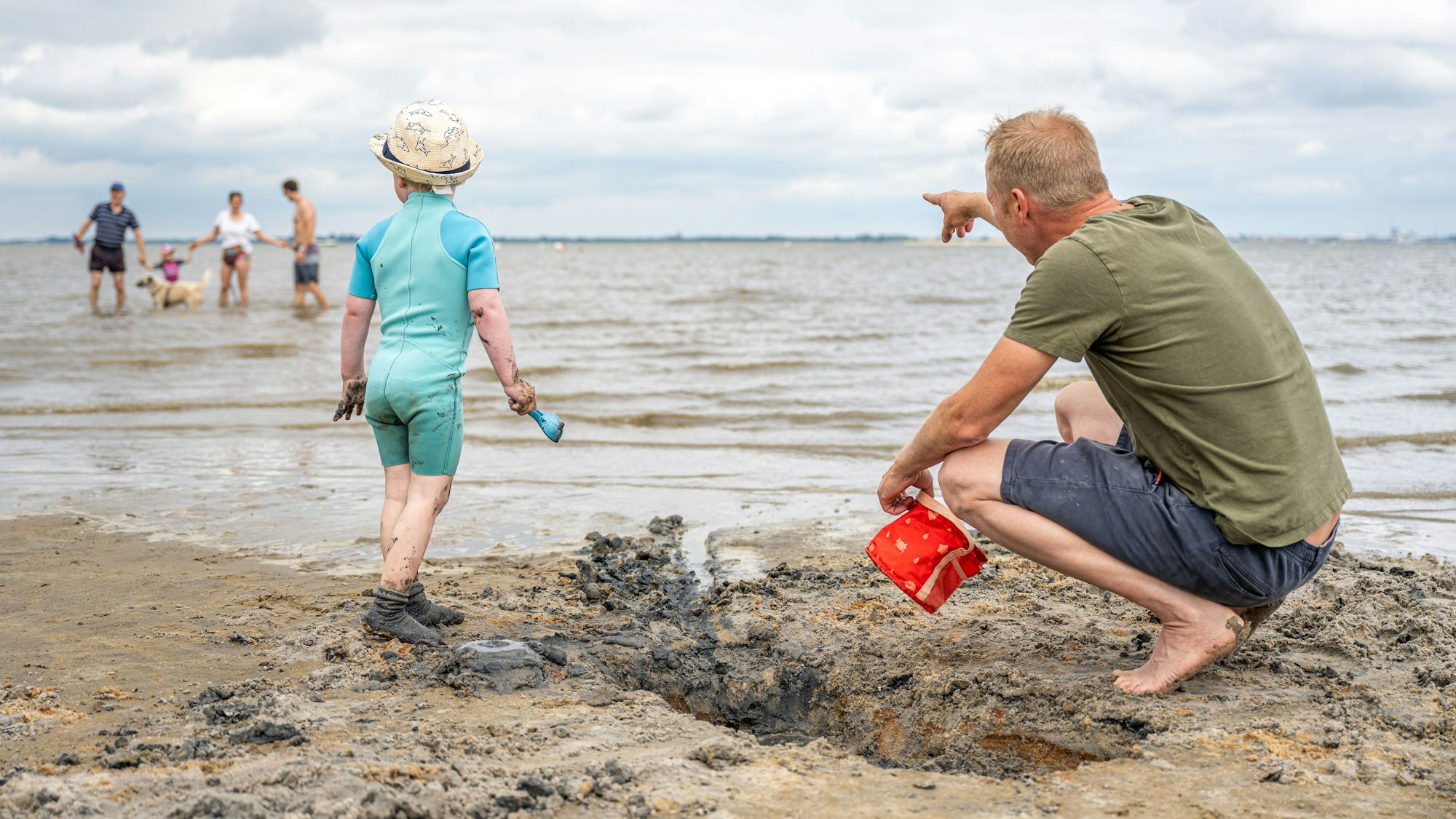 Ein Vater und sein kleiner Sohn sind bei schönem Wetter am Strand. Von solchen Bildern können viele einkommensschwache Familien in NRW nur träumen.