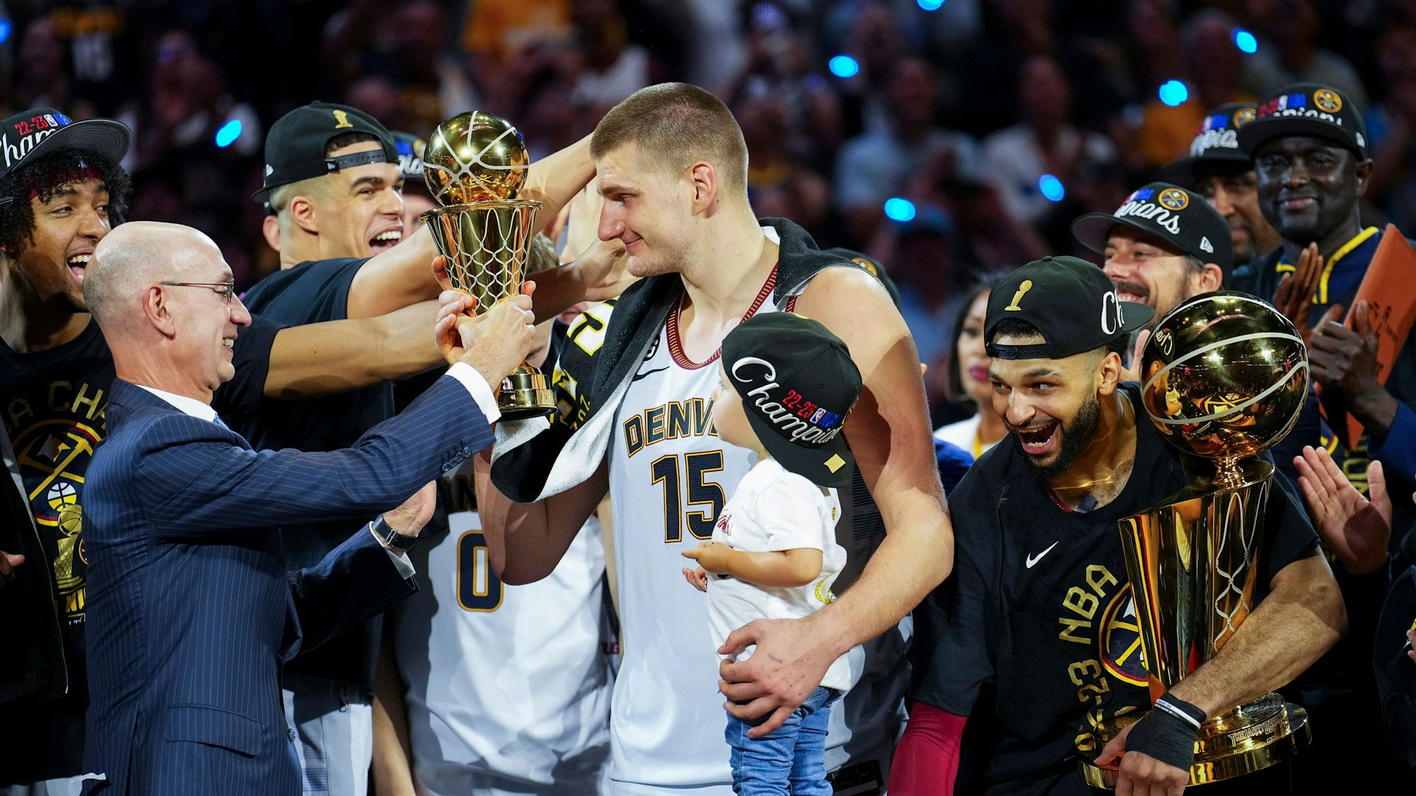 Commissioner Adam Silver (l) überreicht den MVP-Preis an Denver Nuggets-Center Nikola Jokic (M), nachdem das Team die NBA-Meisterschaft gewonnen hat.
