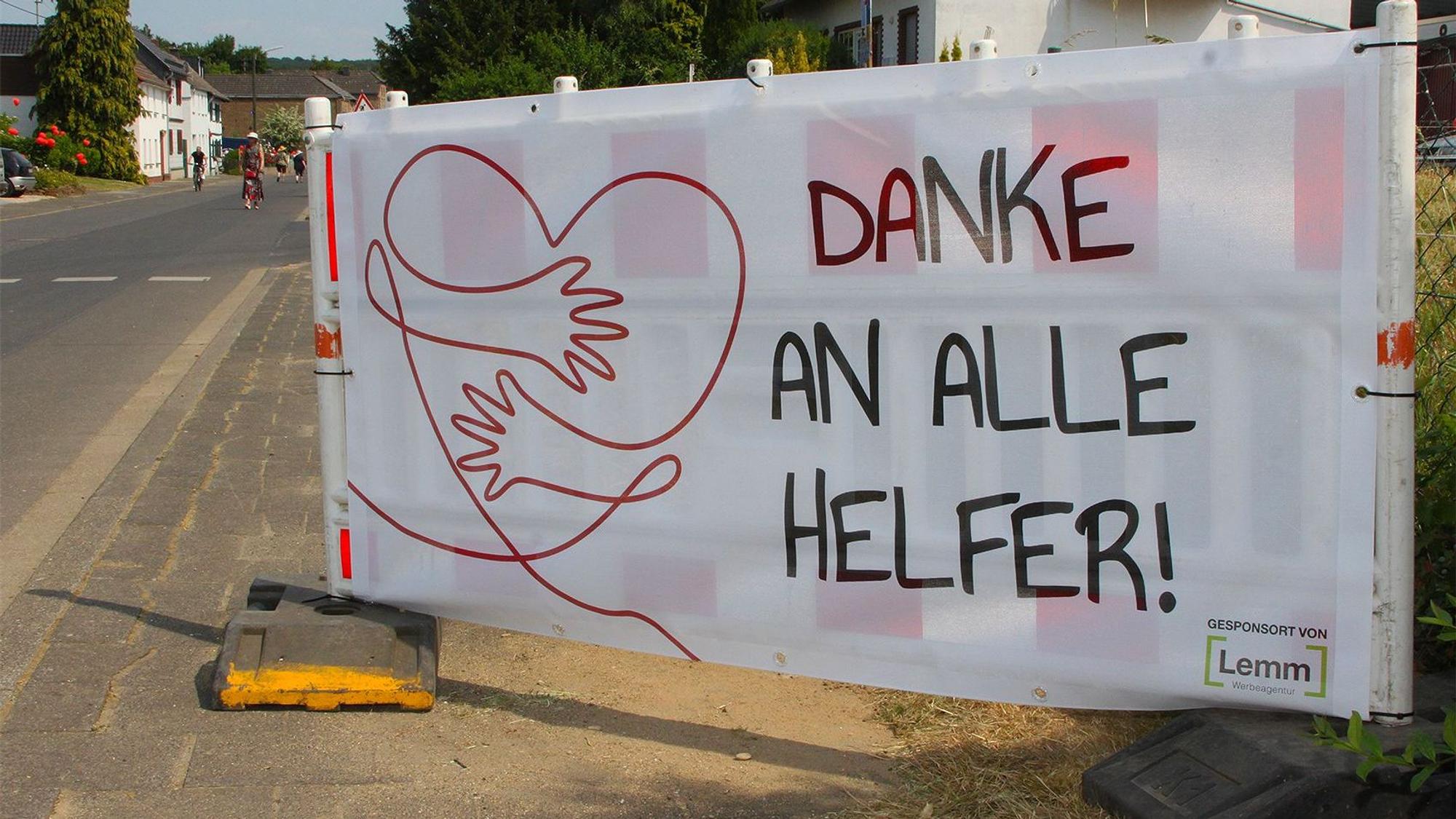 Ein Transparent mit einem Herz-Symbol steht am Ortseingang in Schweinheim.