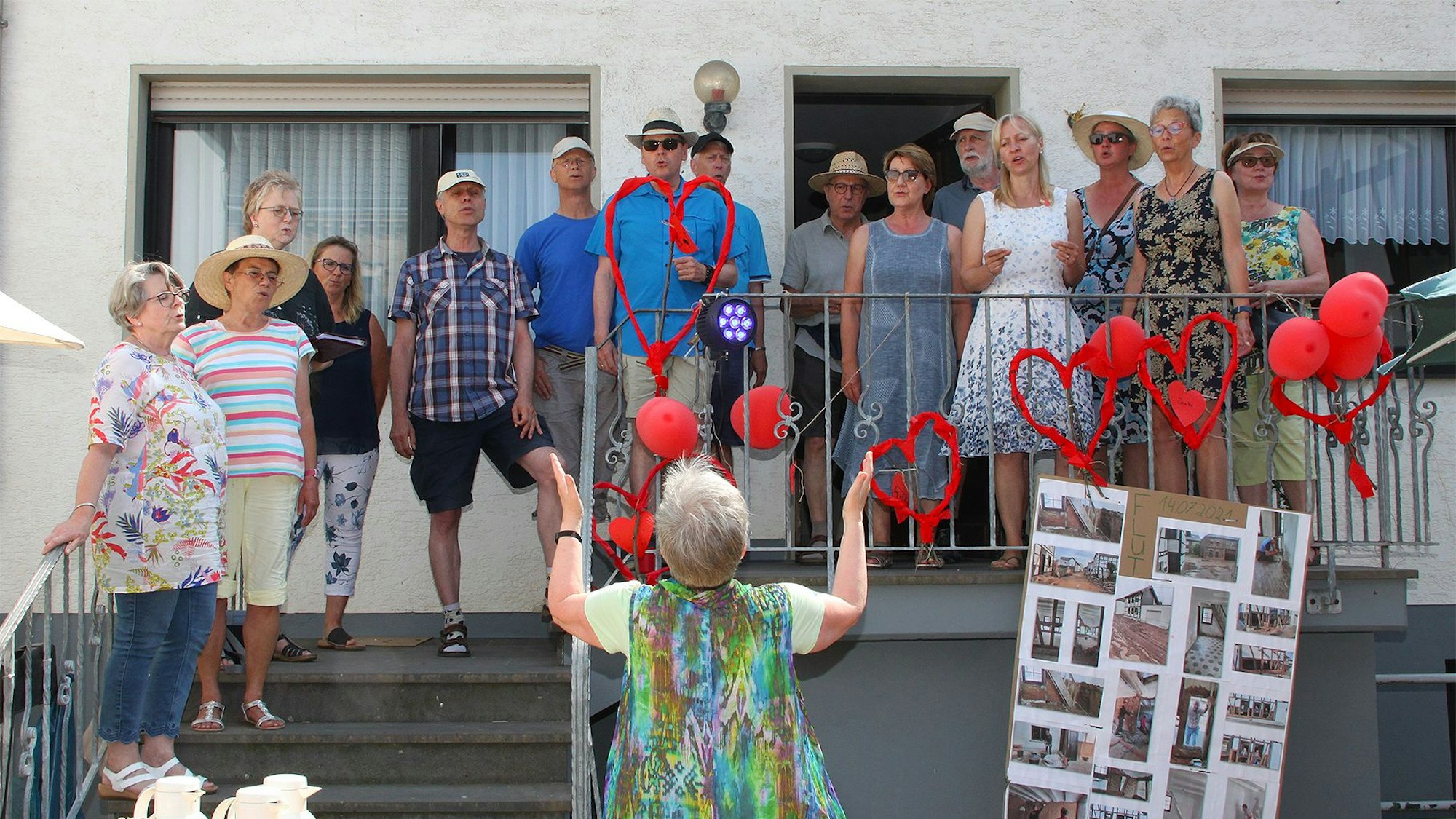 Mehrere Männer und Frauen, Mitglieder eines Chores, singen bei einem Fest in Schweinheim.