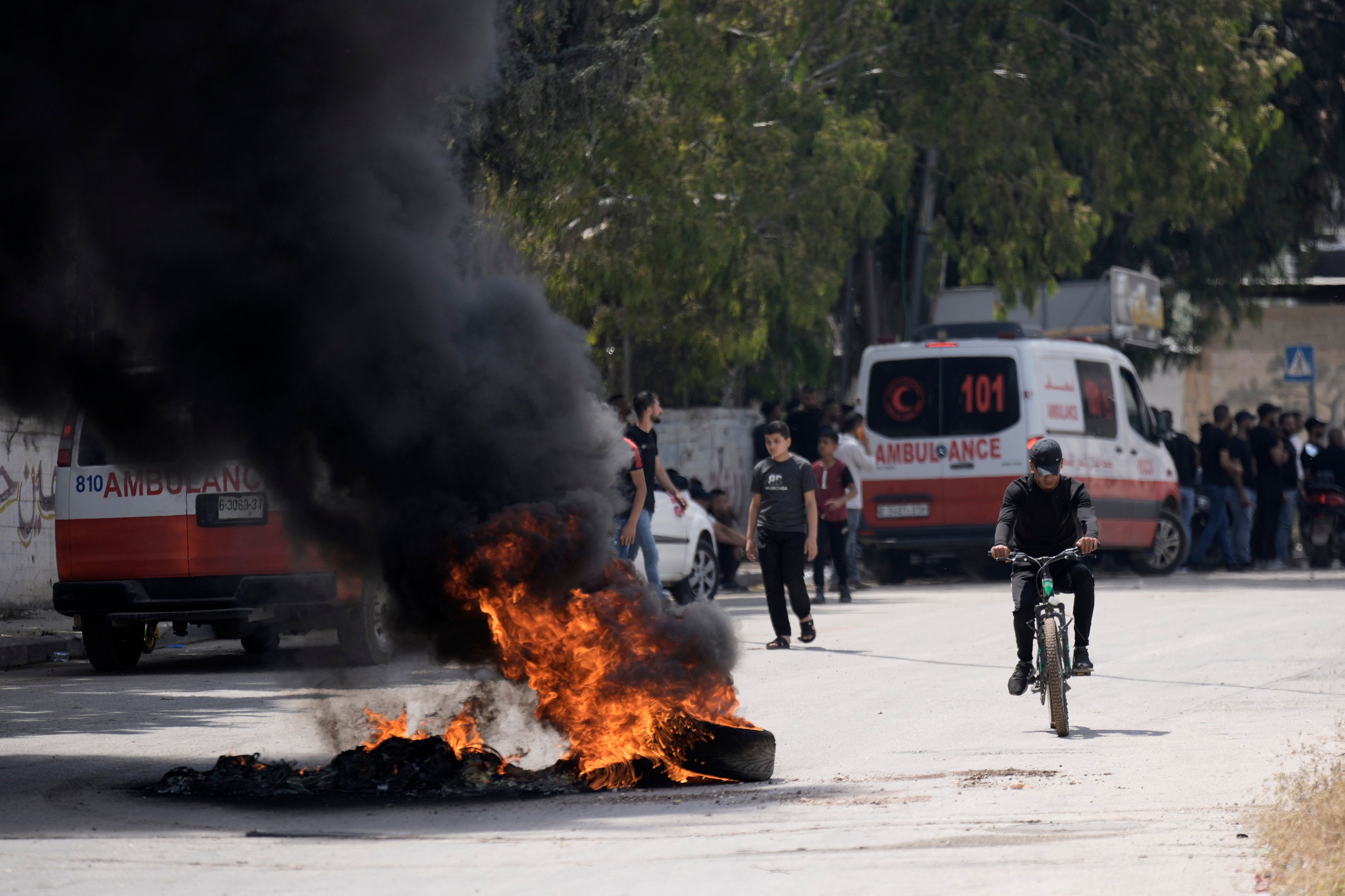 Nach Zusammenstößen zwischen israelischen Streitkräften und militanten Palästinensern liegen brennende Reifen auf der Straße.