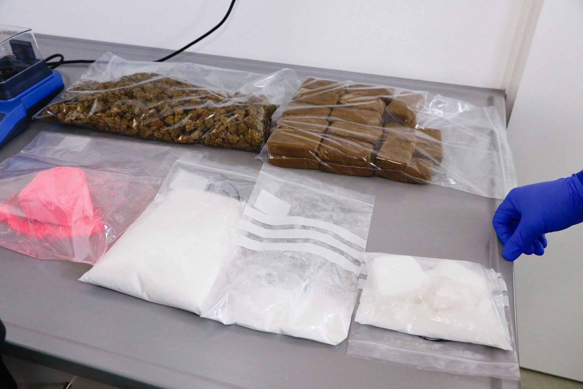 Tagesaktueller Drogenfund: Auf einem Metalltisc liegen Tüten mit Marihuana, Haschisch, Kokain, Amphetamin und „Pink Cocaine“