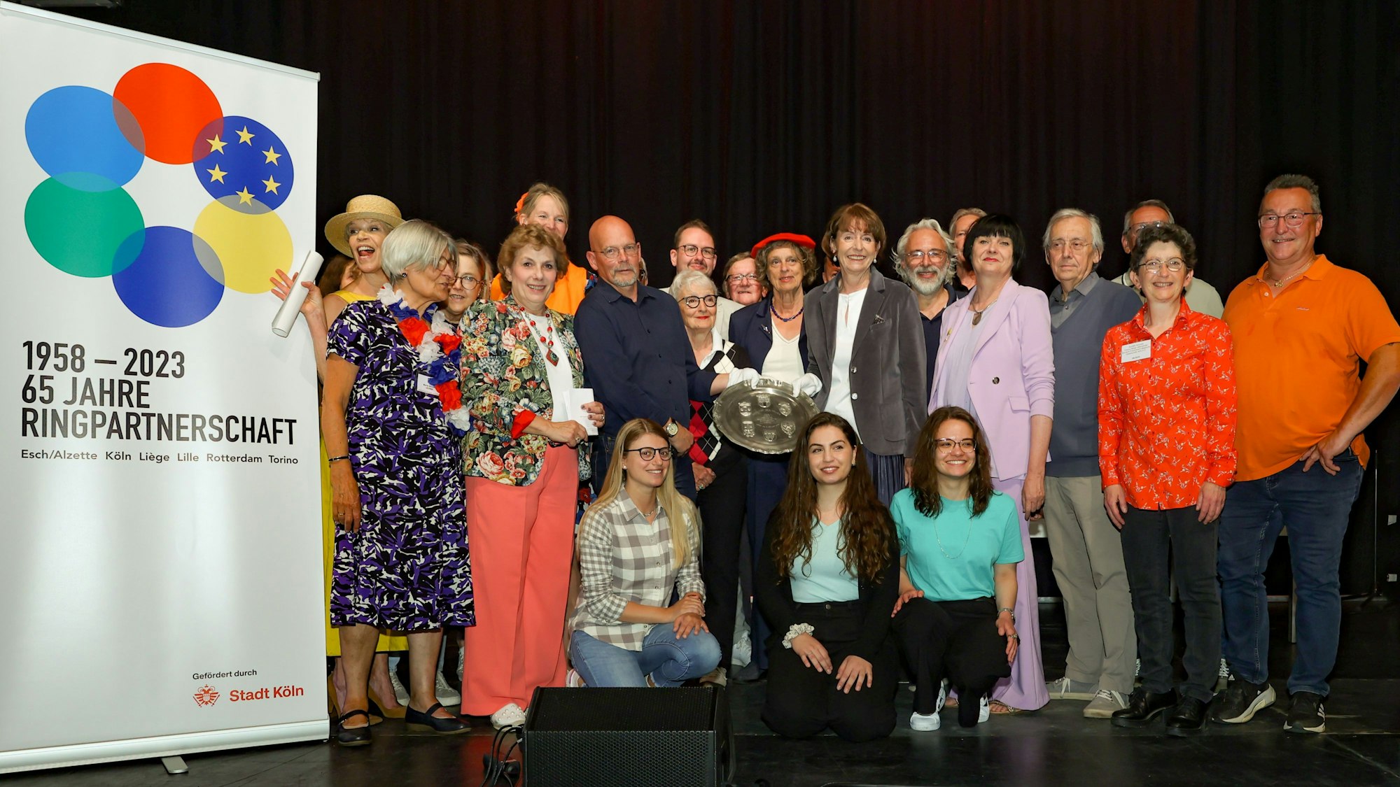 Oberbürgermeisterin Henriette Reker und Gäste aus den Partnerstädten stehen für ein Gruppenbild zusammen.
