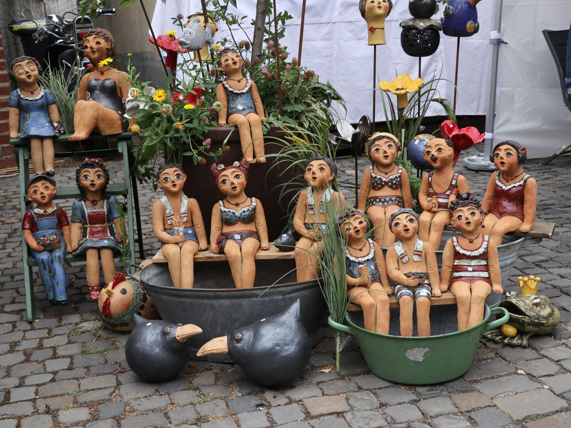 Auf dem Foto sind Keramikfiguren in Badebekleidung zu sehen.