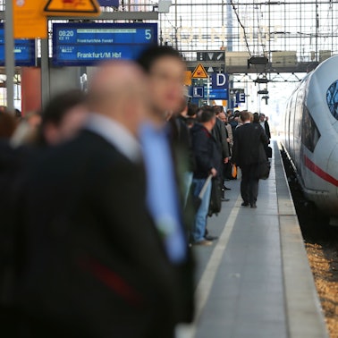 Reisende warten am Kölner Hauptbahnhof auf einen ICE der Deutschen Bahn.