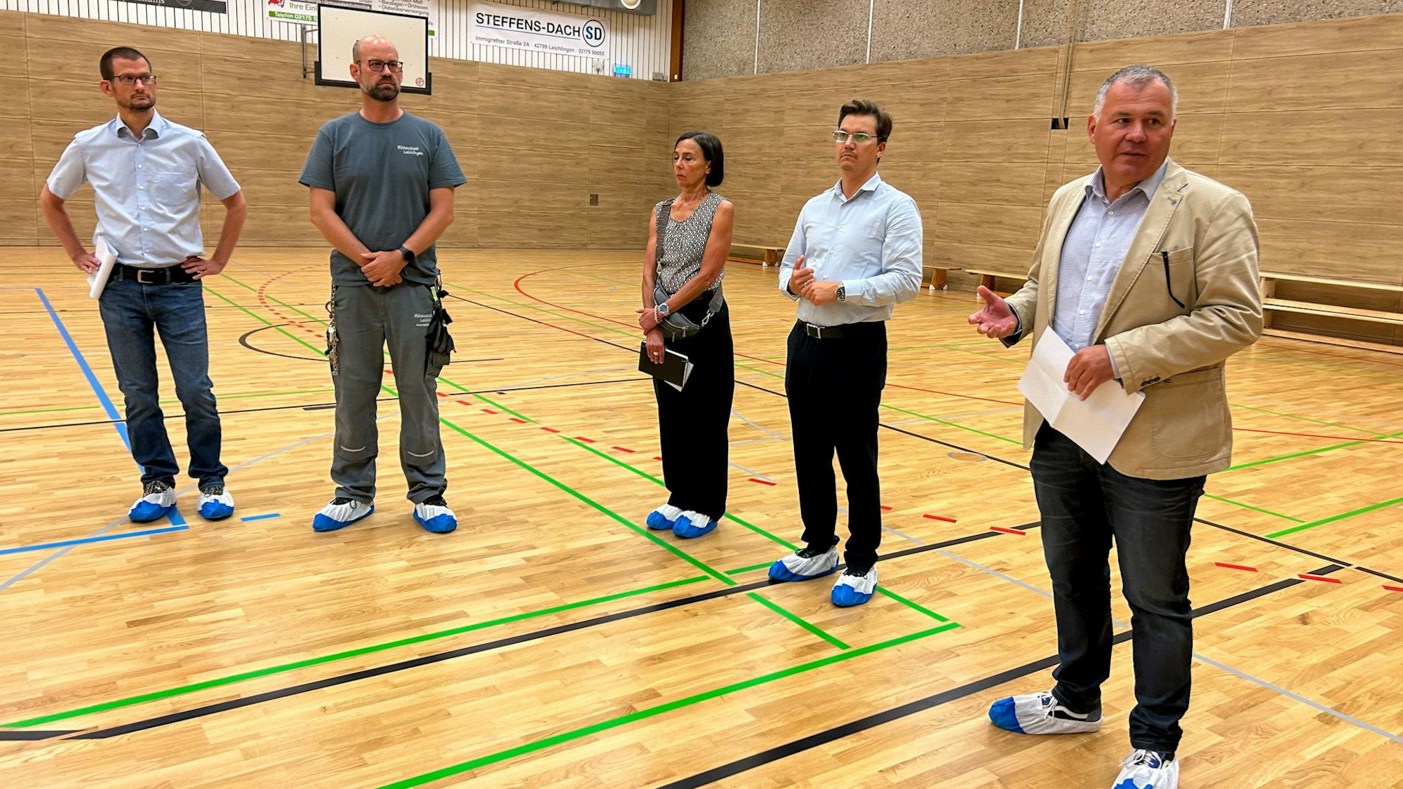 Auch der Boden in der Turnhalle der Sekundarschule wurden erneuert. Bürgermeister Frank Steffes (v.r,), Sebastian Scholze, Fördermanager, Susanne Broch aus der Gebäudewirtschaft, Andreas Wünsche, Gebäudewirtschaft, Martin Jagusch, Tiefbauamtsleiter.