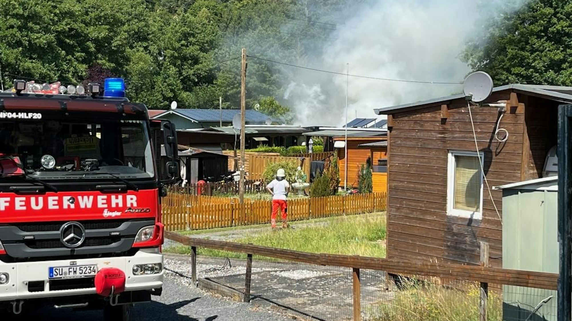 Feuerwehrleute im Einsatz auf einem Campingplatz.
