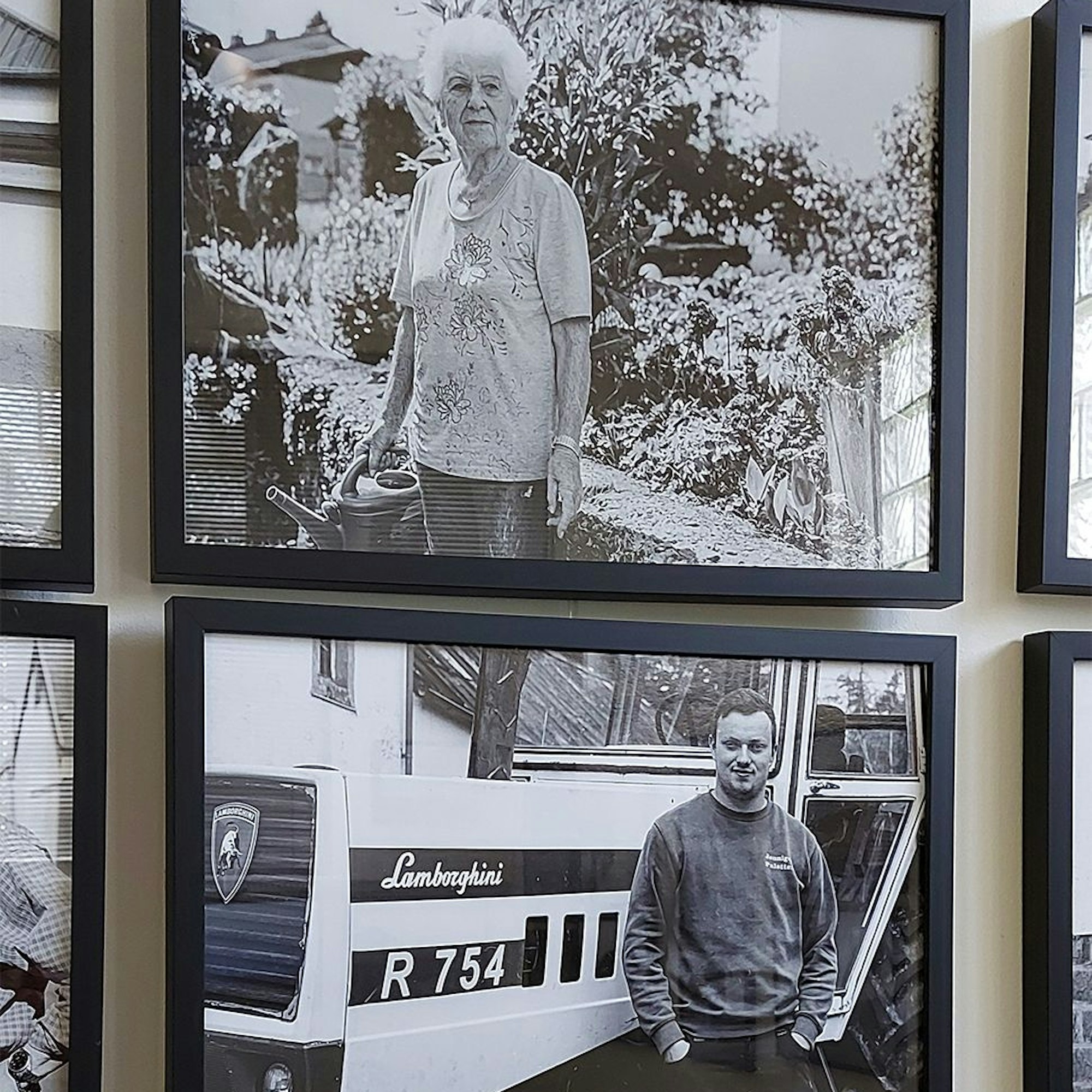 Das Bild zeigt einen Mann und eine Frau, jeweils auf gerahmten Schwarz-Weiß-Fotos, die in einer Ausstellung gezeigt werden.