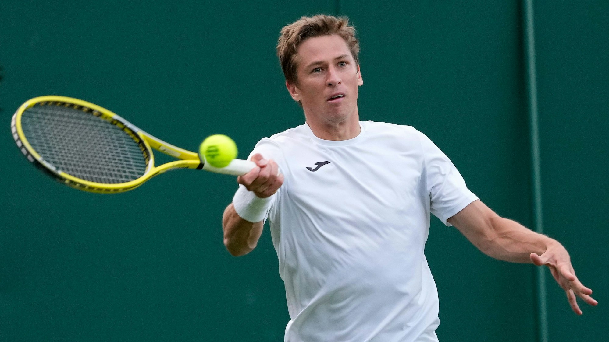 Belgium's Kimmer Coppejans returns to Australia's Alex de Minaur in a first round men's singles match on day three of the Wimbledon tennis championships in London, Wednesday, July 5, 2023. (AP Photo/Kirsty Wigglesworth)