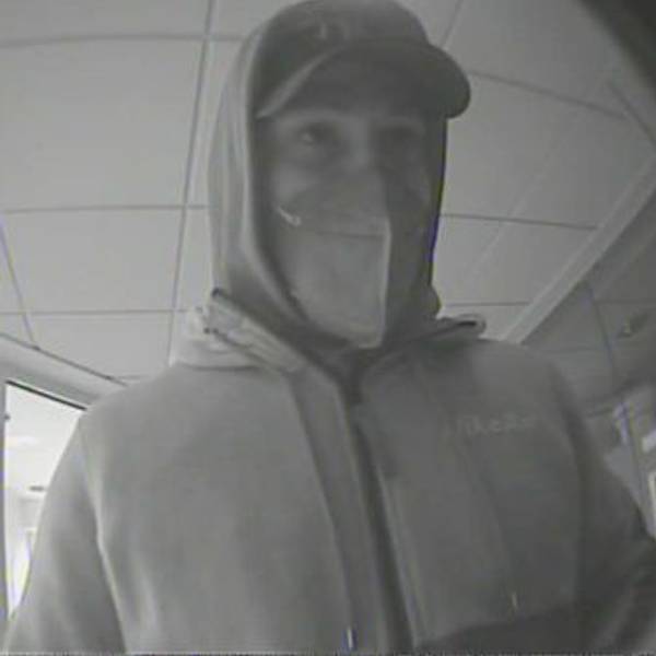Das Bild zeigt einen Mann mit Kapuzenpulli und Basecap, der von der Überwachungskamera der Bank gefilmt wurde.