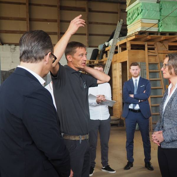 Das Bild zeigt NRW-Ministerin Ina Scharrenbach im Gespräch mit dem dem Bauunternehmer Bastian Boße.