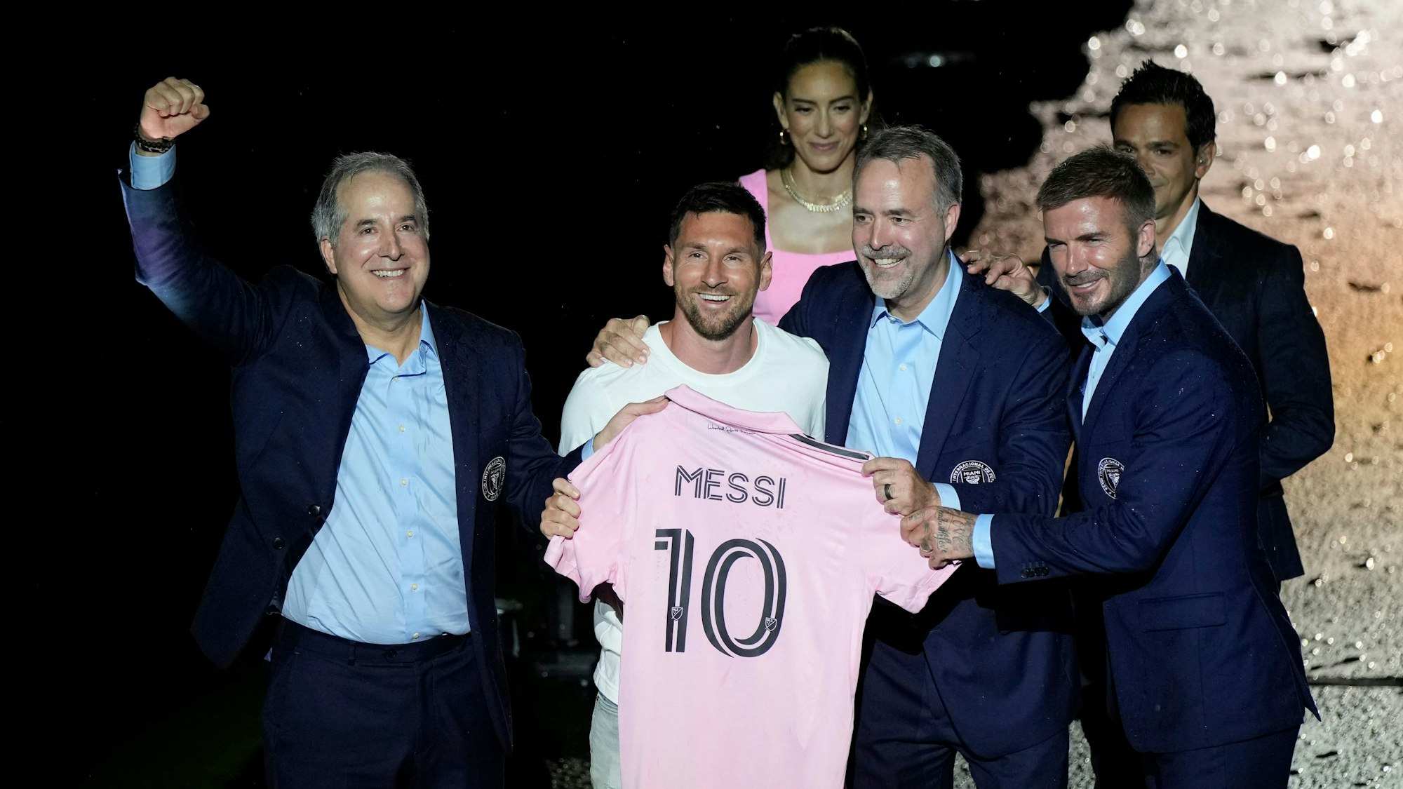 Lionel Messi (Mitte links) von Inter Miami hält sein neues Trikot in der Hand, neben den Miteigentümern Jorge Mas (l.), Jose Mas (2.v.r) und David Beckham (r.) während einer Feier im DRV Pink Stadium in Florida.