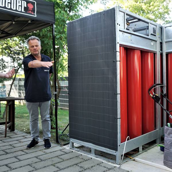 Zwei Männer stehen vor Tanks, die mit Wasserstoff gefüllt sind.