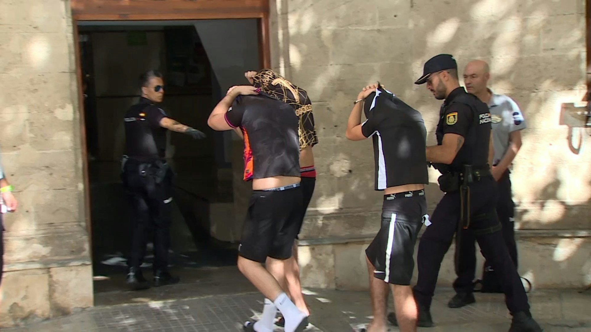 Polizisten führen die Verdächtigen zum Termin mit dem Haftrichter auf Mallorca. Gegen fünf Urlauber aus NRW sind auf Mallorca schwere Vorwürfe erhoben worden. Die Polizei ermittelt wegen einer Gruppenvergewaltigung.