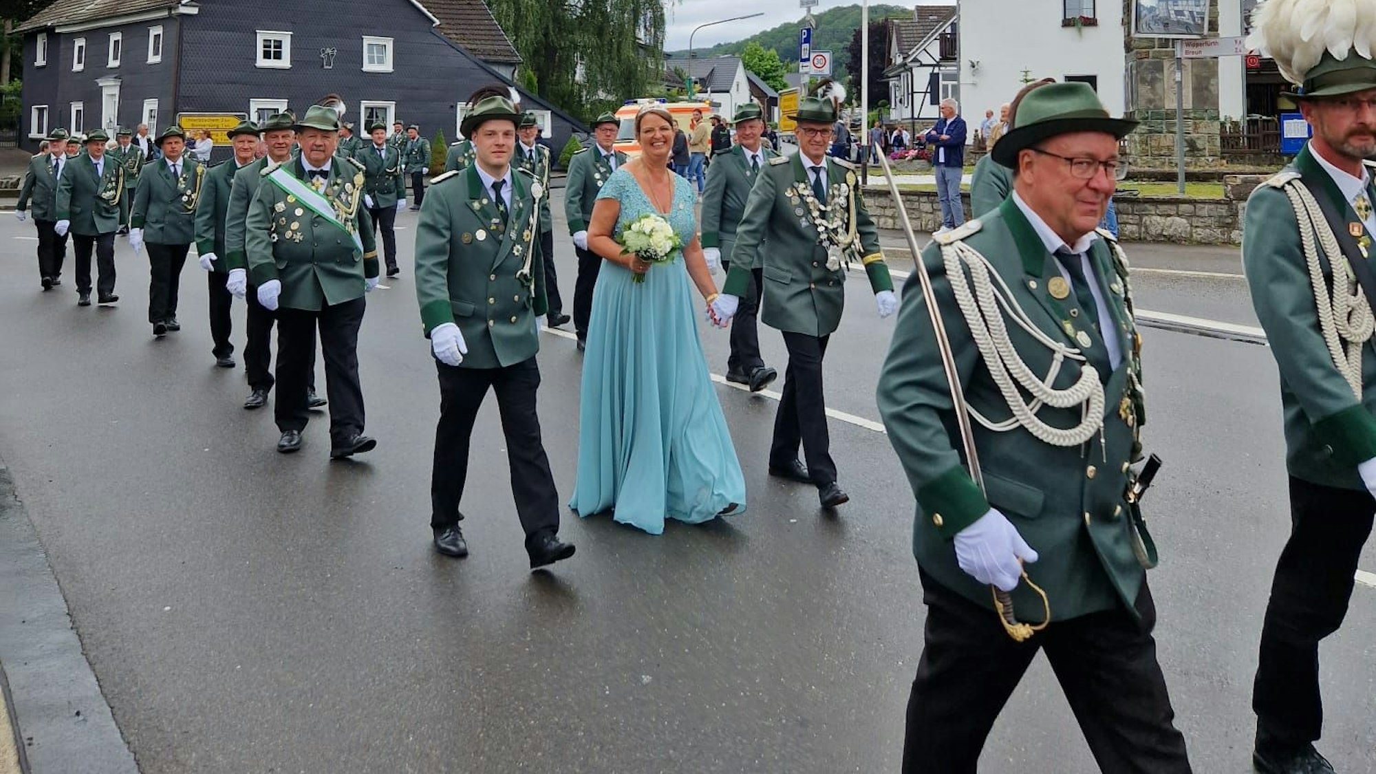 Schützen bei einem Festumzug auf einer Straße.