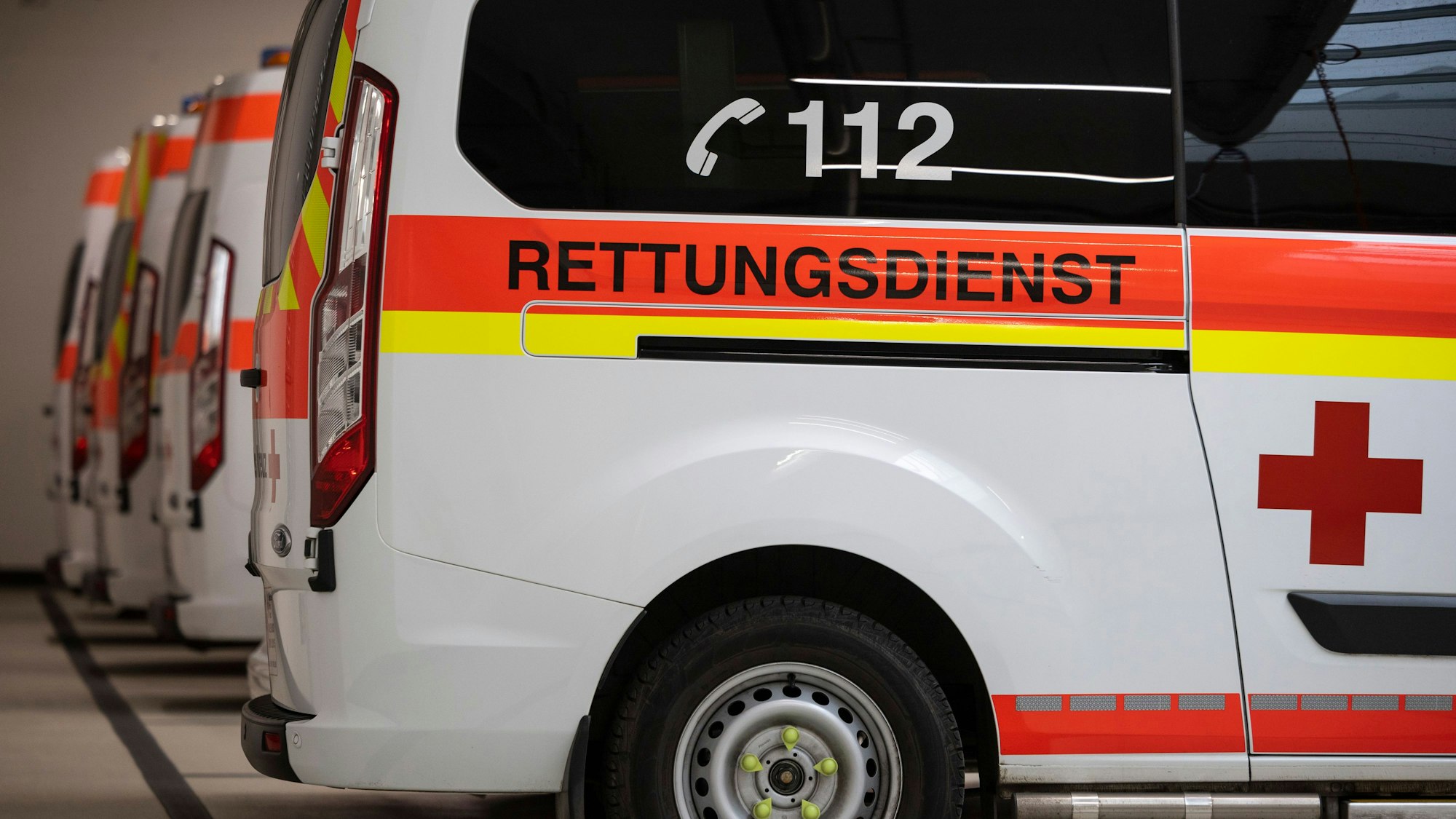 Rettungswagen stehen aufgereiht in der Garage in einer Rettungswache des Deutschen Roten Kreuzes (DRK).