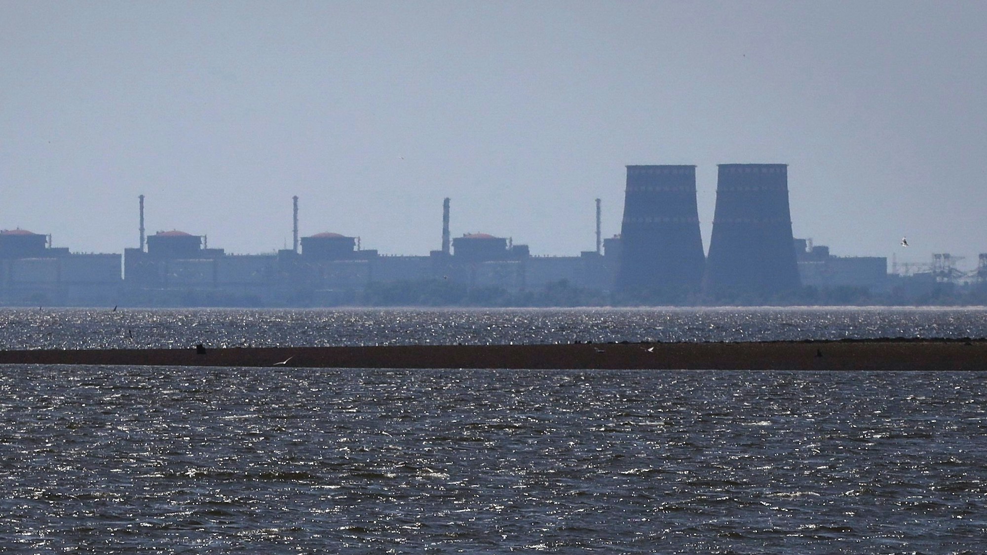 Das Kernkraftwerk Saporischschja ist im Hintergrund des flachen Kachowka-Stausees nach der Zerstörung des Staudamms zu sehen.