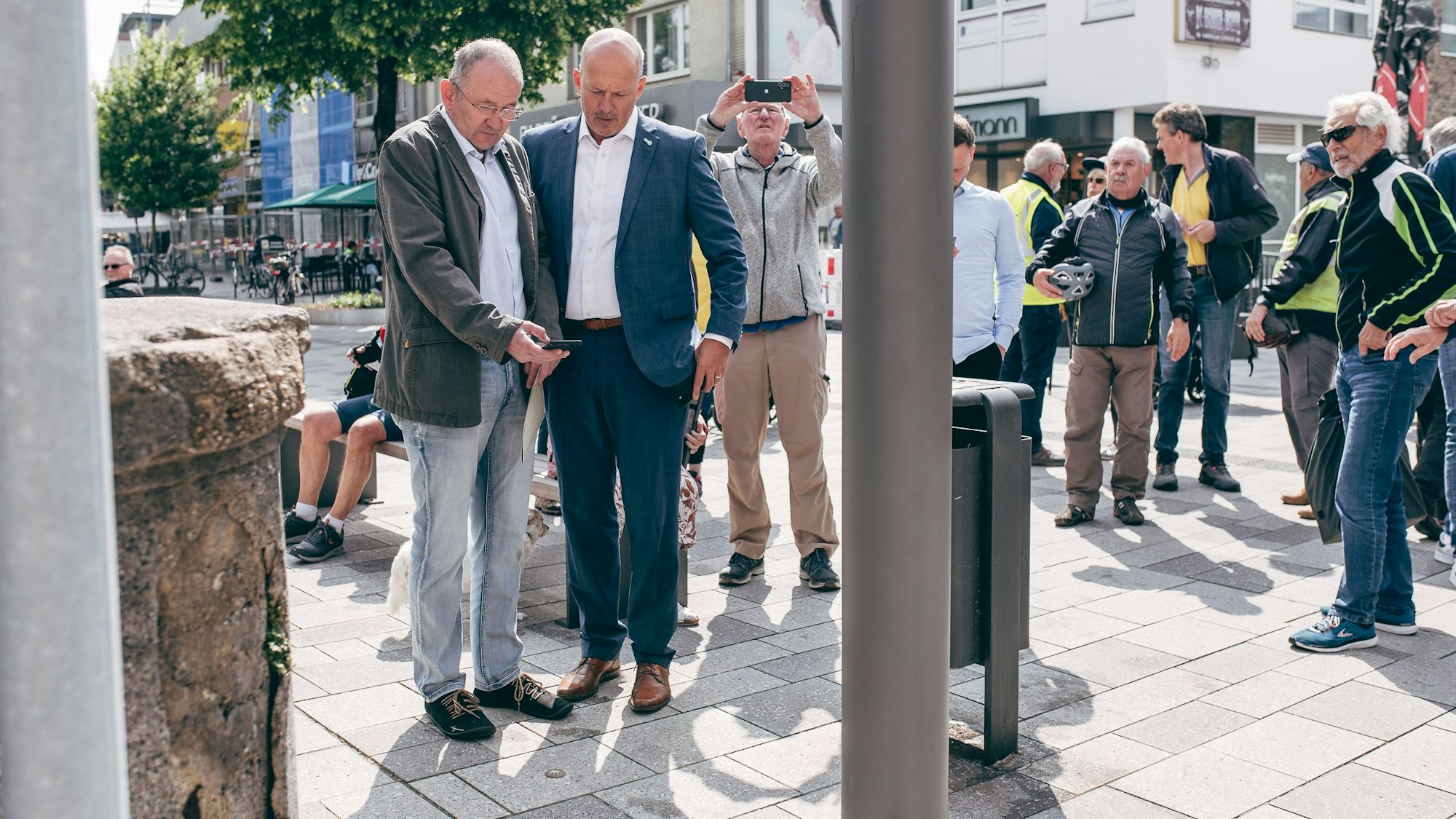 Das Bild zeigt mehrere Menschen, darunter Landrat Frank Rock, die um den GPS-Punkt stehen.