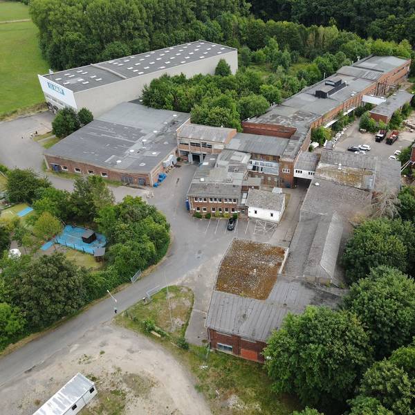 Luftbild eines Industrieunternehmens mit alten und neuen Gebäuden.