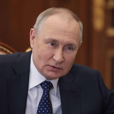 Der russische Präsident Wladimir Putin sitzt während einer Besprechung an einem langen Tisch im Kreml.