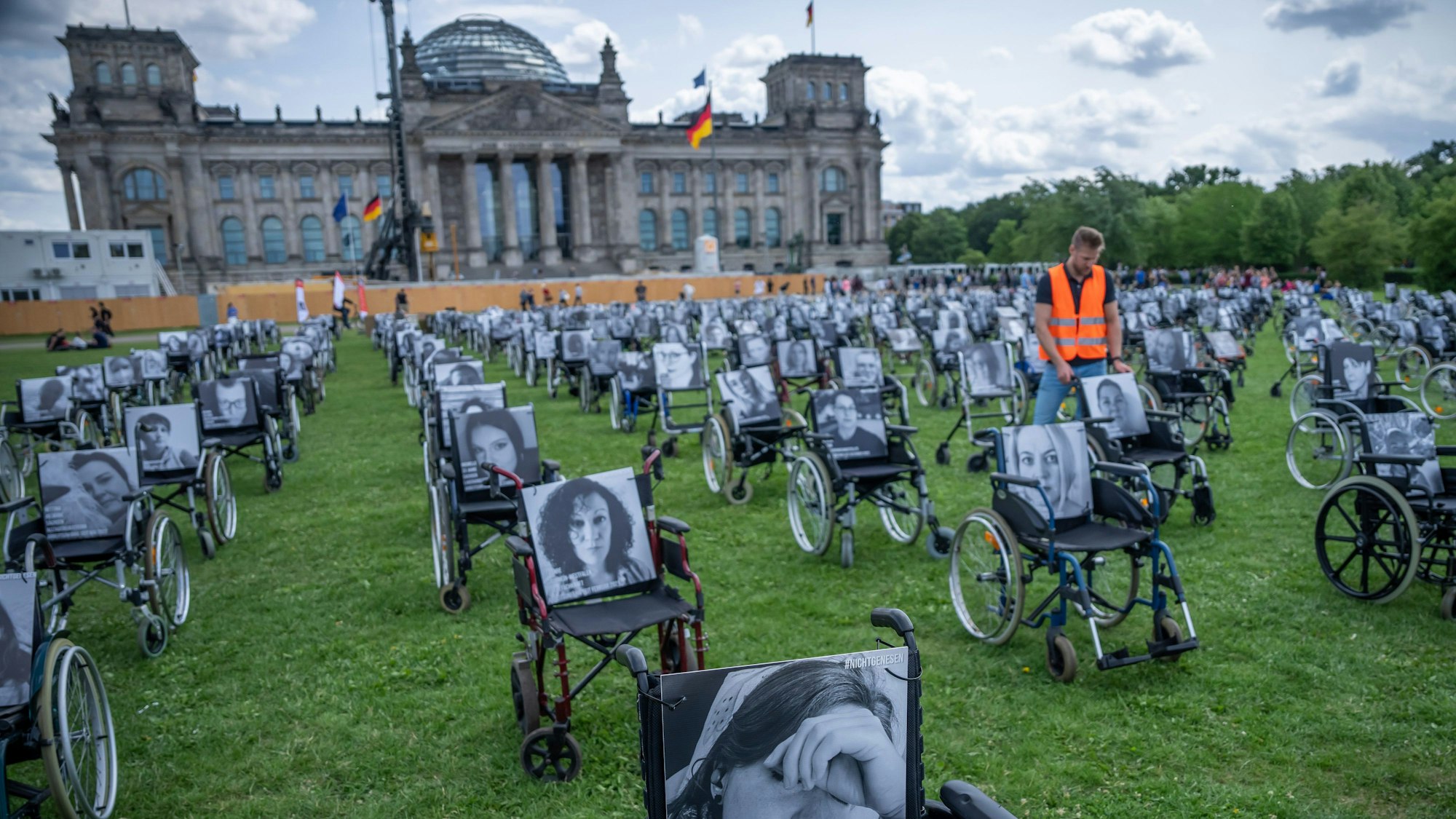 Aktion der Aktion „Nichtgenesen“ Anfang Juli vor dem Reichstag in Berlin. Auf den Rollstühlen stehen Bilder mit Namen von Long Covid, ME/CFS und Post Vac- Betroffenen.
