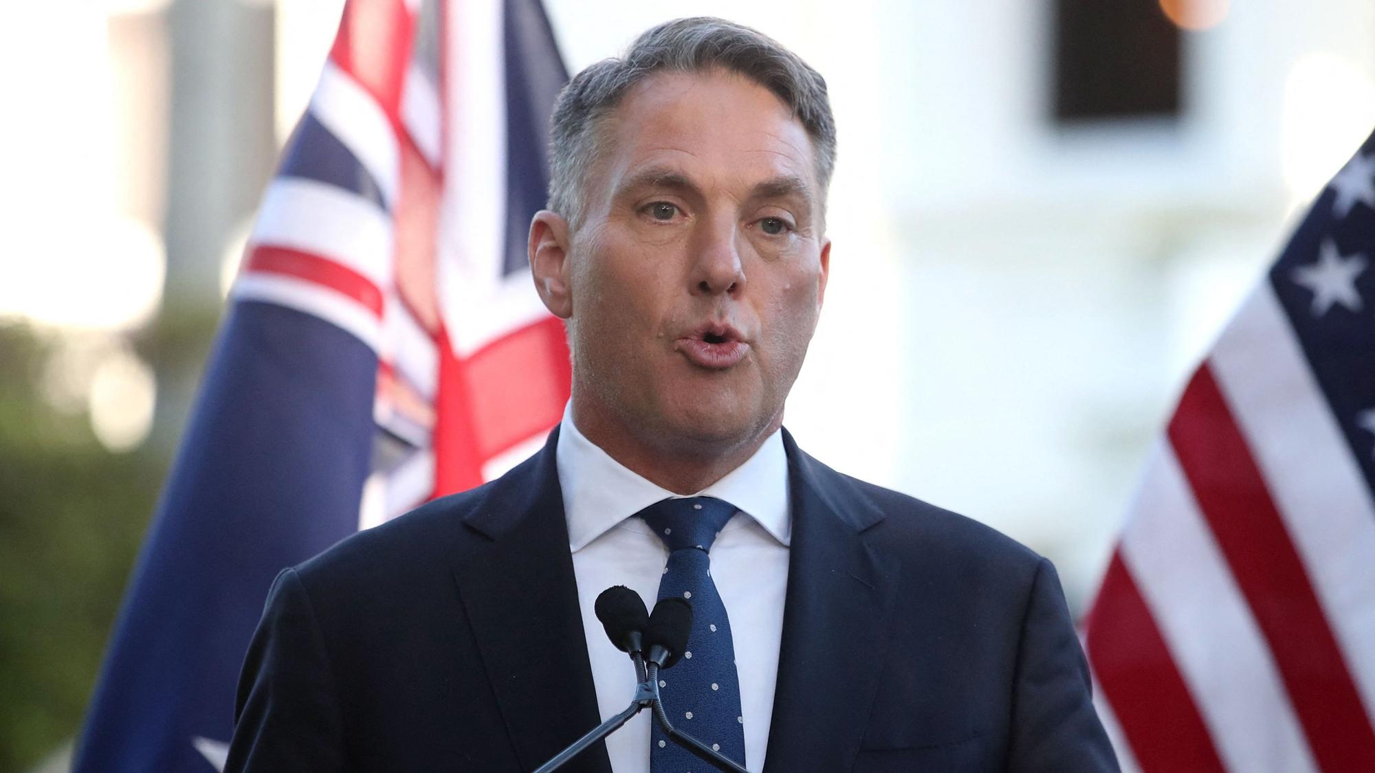 Australiens Verteidigungsminister Minster Richard Marles spricht vor einer australischen und amerikanischen Flagge auf einer Pressekonferenz. (Symbolbild)