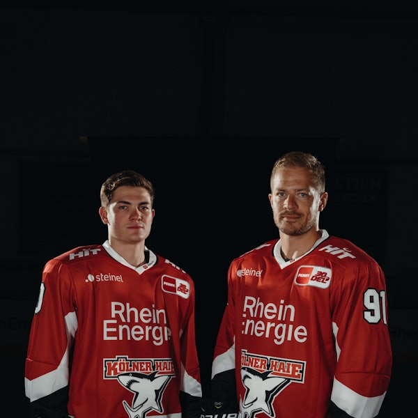 Neuzugang Justin Schütz (l.) und KEC-Kapitän Moritz Müller präsentieren das neue Heimtrikot der Kölner Haie.