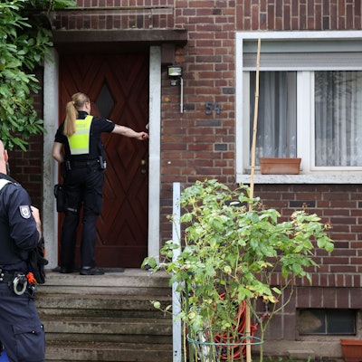 Zwei Einsatzkräfte des Ordnungssamtes klingeln an einer Haustür bei einer Evakuierung nach einem Bombenfund in Köln.