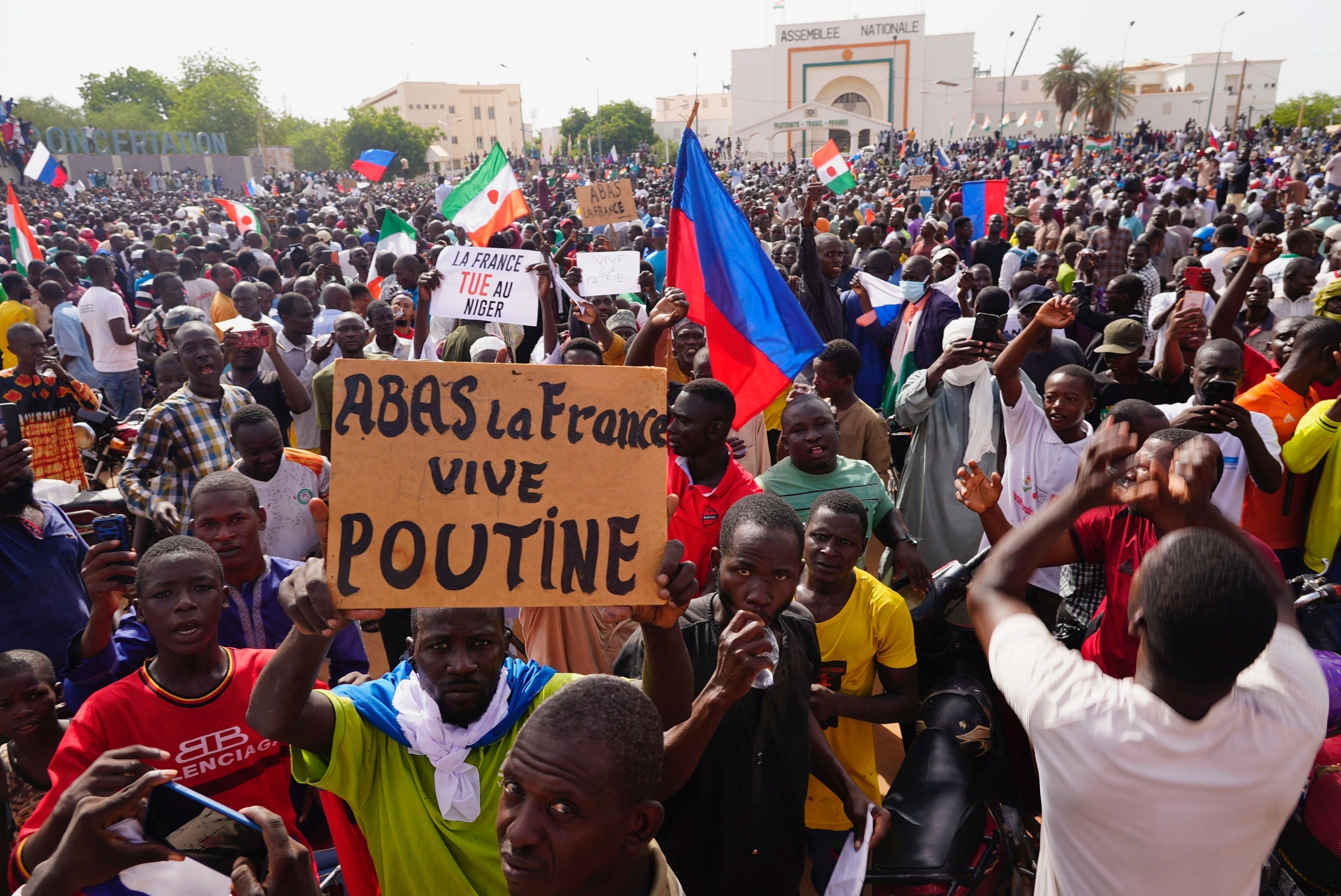 FILE - Nigeriens participate in a march called by supporters of coup leader Gen. Abdourahmane Tchiani in Niamey, Niger, Sunday, July 30, 2023. The French Foreign Ministry says Tuesday, Aug.1, 2023 France is planning an imminent evacuation of people seeking to leave Niger after the coup last week in the former French colony. Poster reads: Down with France, long live Putin." (AP Photo/Sam Mednick, File)