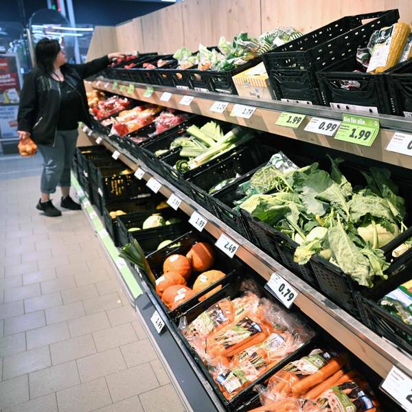 A woman chooses products from the fruit and vegetable counter at a store of the Penny supermarket chain in Berlin, Germany, on August 1, 2023.
