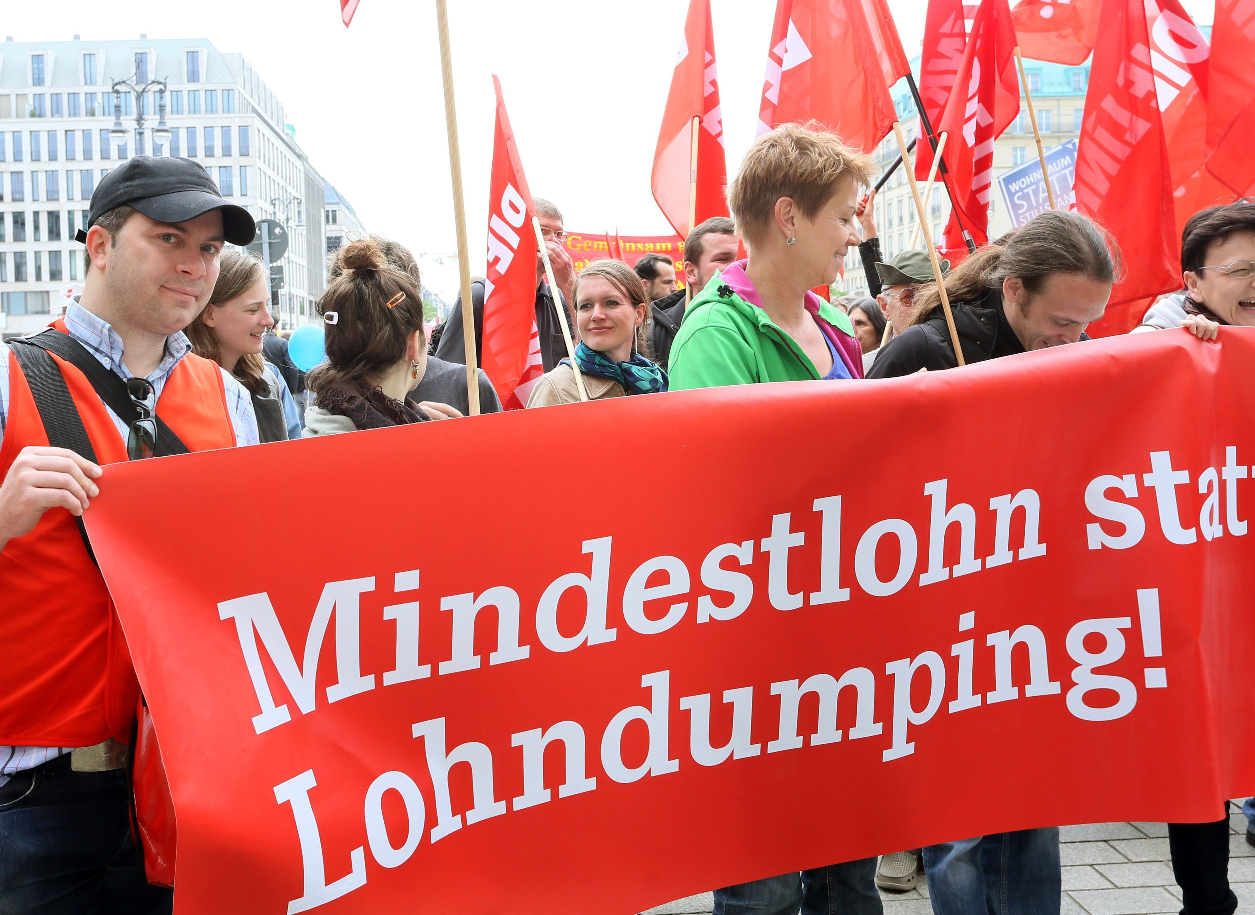 „Mindestlohn statt Lohndumping!“ steht auf einem Transparent, das Demonstranten bei der Kundgebung des Deutschen Gewerkschaftsbundes DGB zum 1. Mai halten.