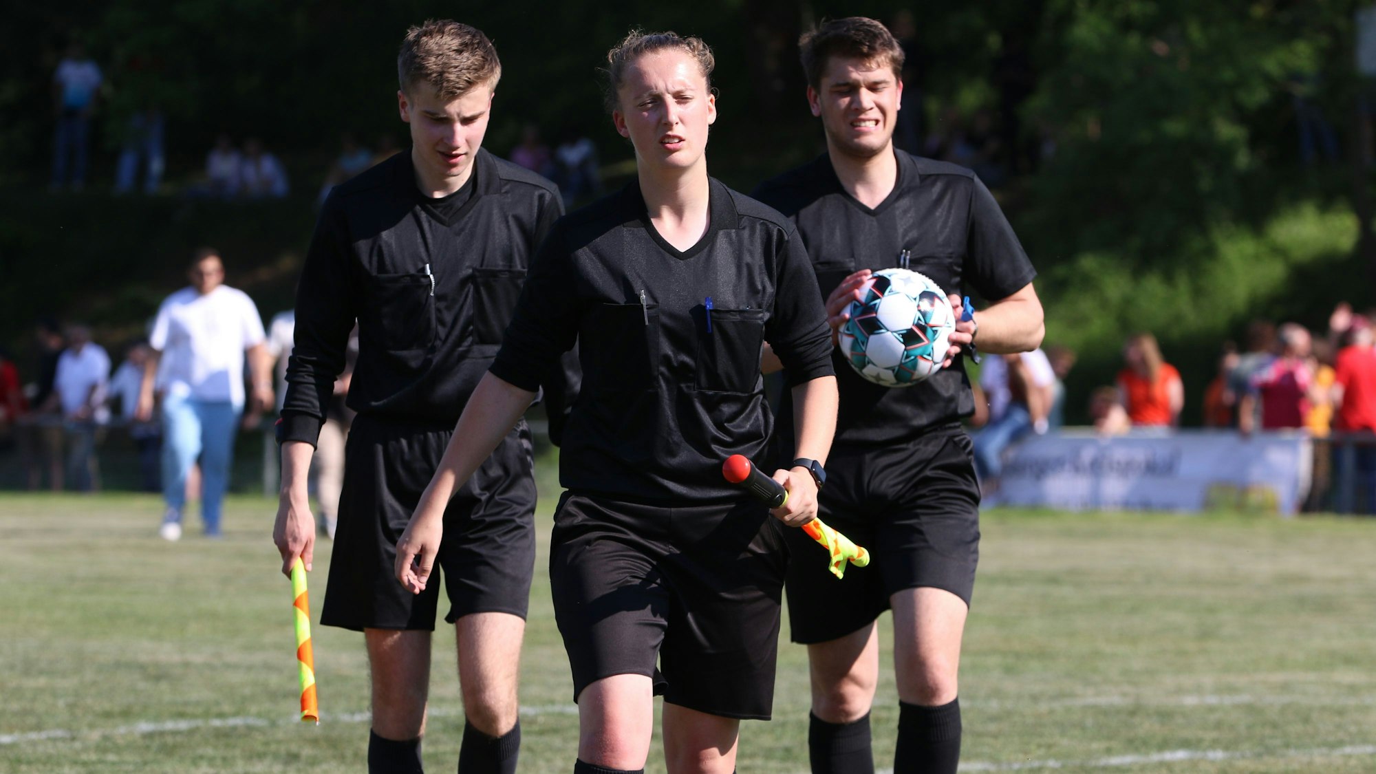 Das Bild zeigt ein Schiedsrichtergespann beim Gang in die Kabine. Lisa Reinecke geht vorne weg.