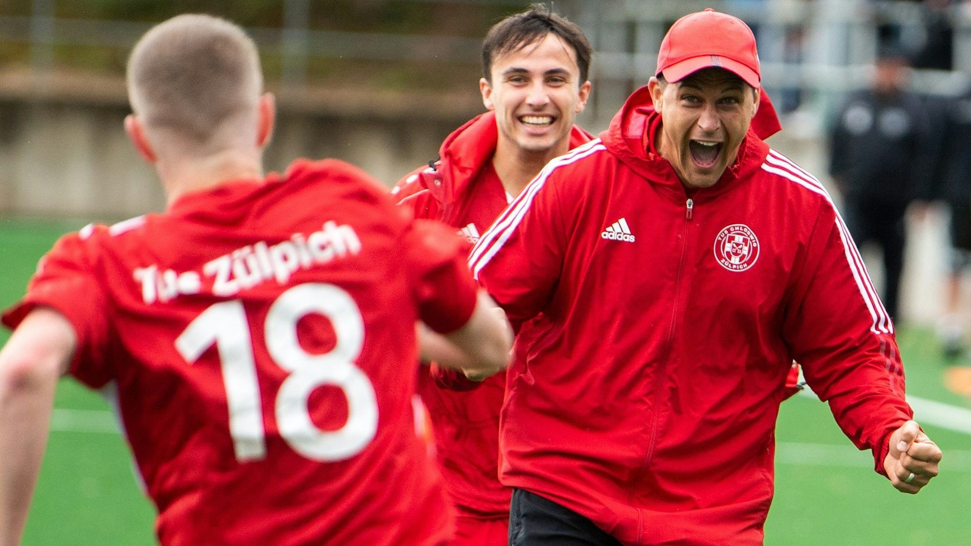 Das Bild zeigt den Zülpicher Trainer, der mit geballten Fäusten und aufgerissenem Mund auf seinen Spieler zuläuft.