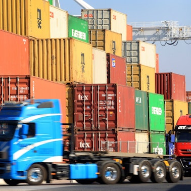 Am Hafen in Duisburg werden Container auf Lkw verladen.