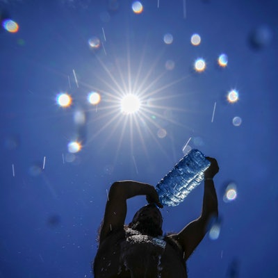 FILE - A man pours cold water onto his head to cool off on a sweltering hot day in the Mediterranean Sea in Beirut, Lebanon, July 16, 2023. European climate monitoring organization made it official: July 2023 was Earth's hottest month on record by a wide margin. (AP Photo/Hassan Ammar, File)
