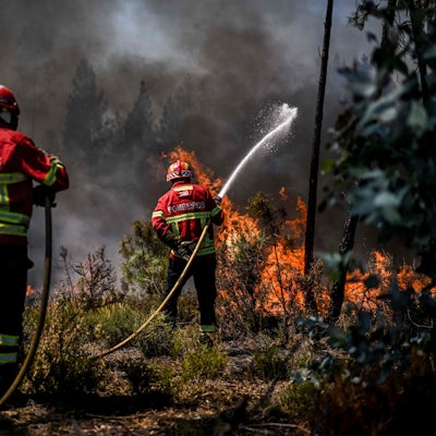 TOPSHOT - Firefighters battle a wildfire in Carrascal, Proenca a Nova on August 6, 2023. More than 1,000 firefighters battled a wildfire in central Portugal today as officials warned that thousands of hectares were at risk amid soaring temperatures across the country. (Photo by Patricia DE MELO MOREIRA / AFP)